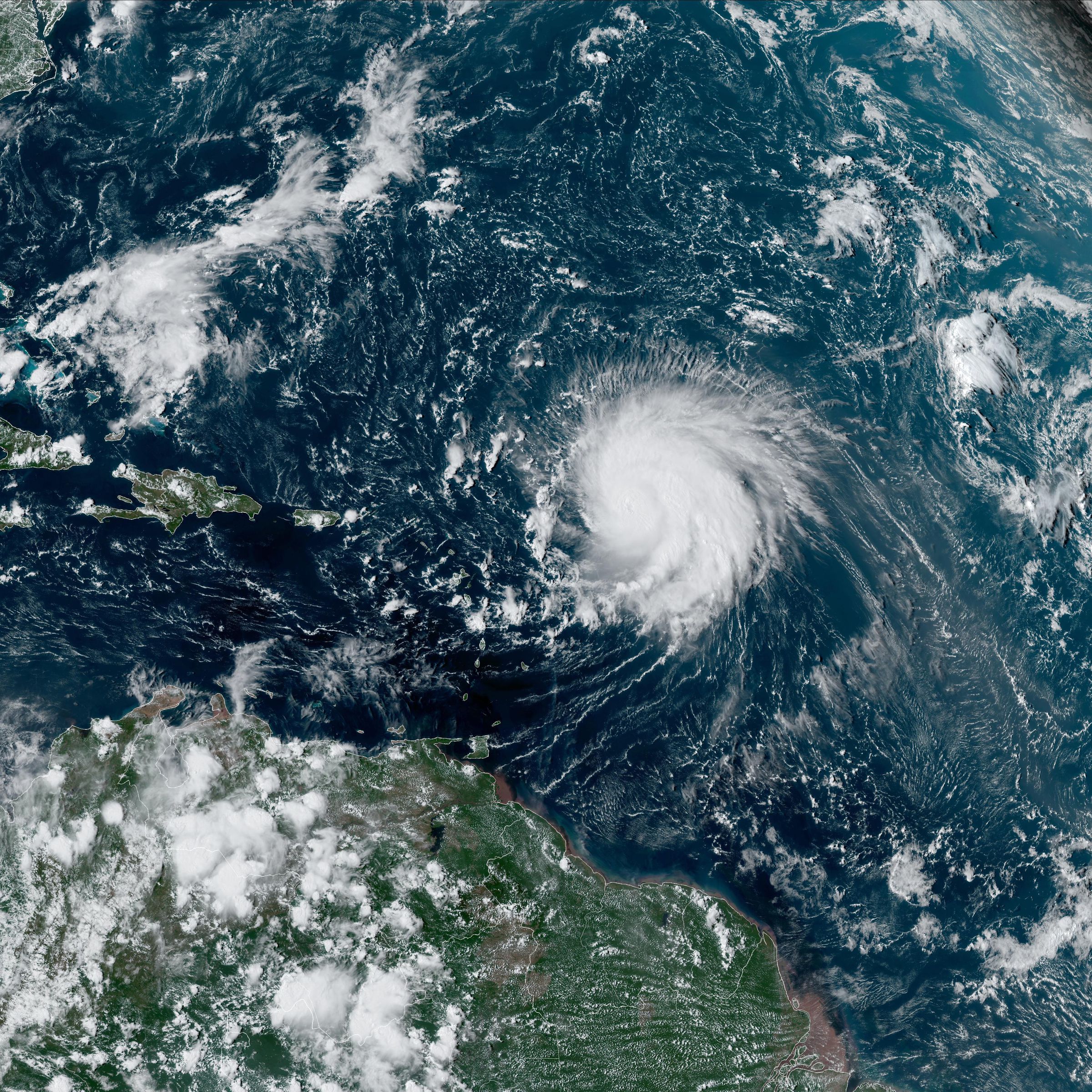 A satellite image of the Atlantic ocean seen from space, with a large storm swirling over the water.