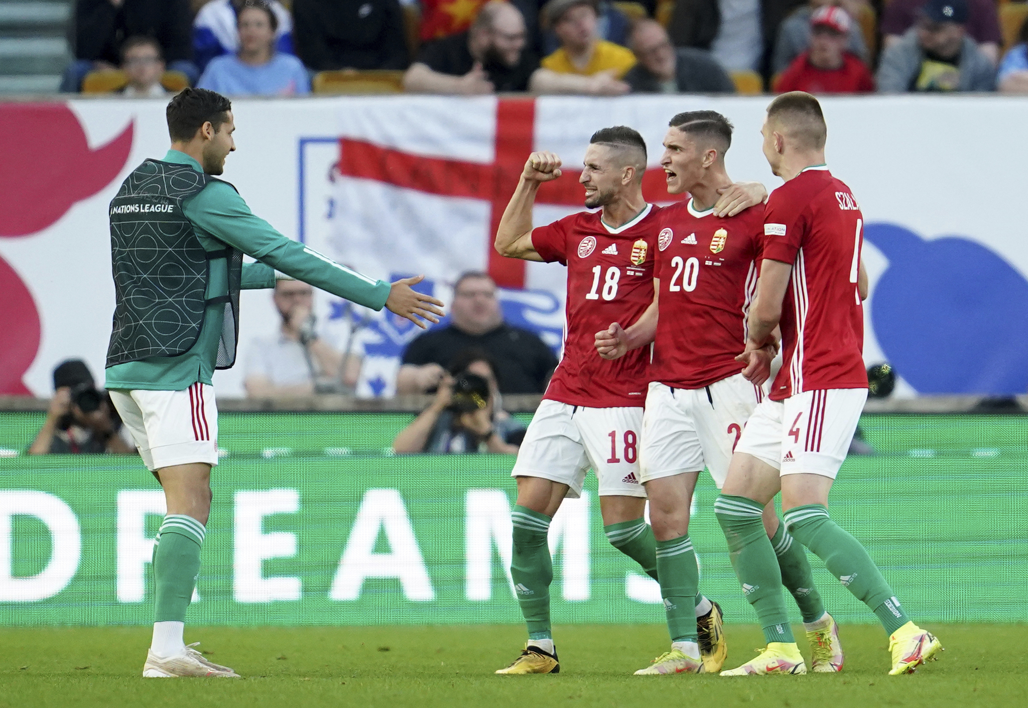 Roland Sallai celebrates with teammates after scoring his sides second goal.