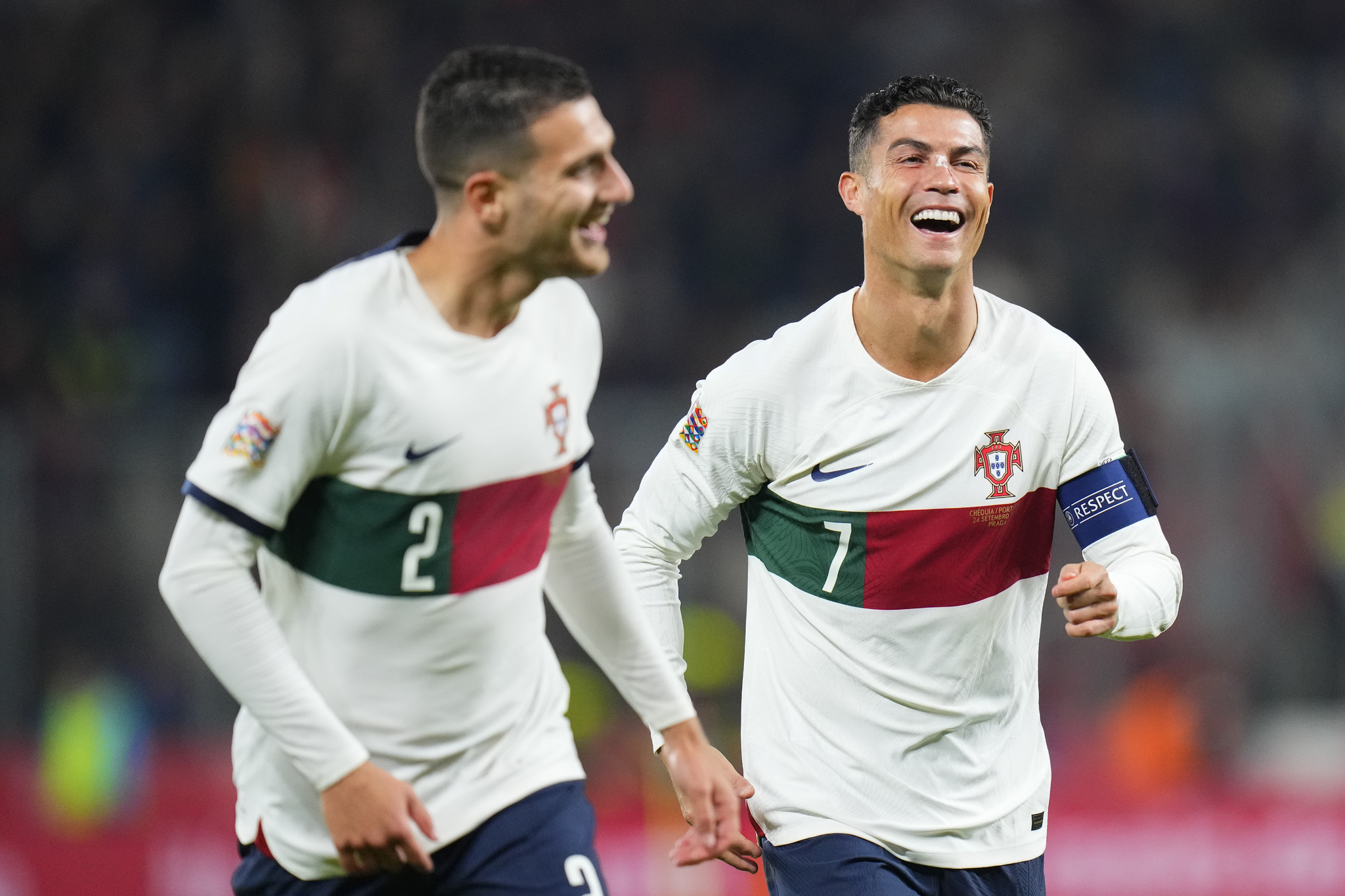 Portugals Diogo Dalot, who scored his sides third goal, celebrates with Cristiano Ronaldo