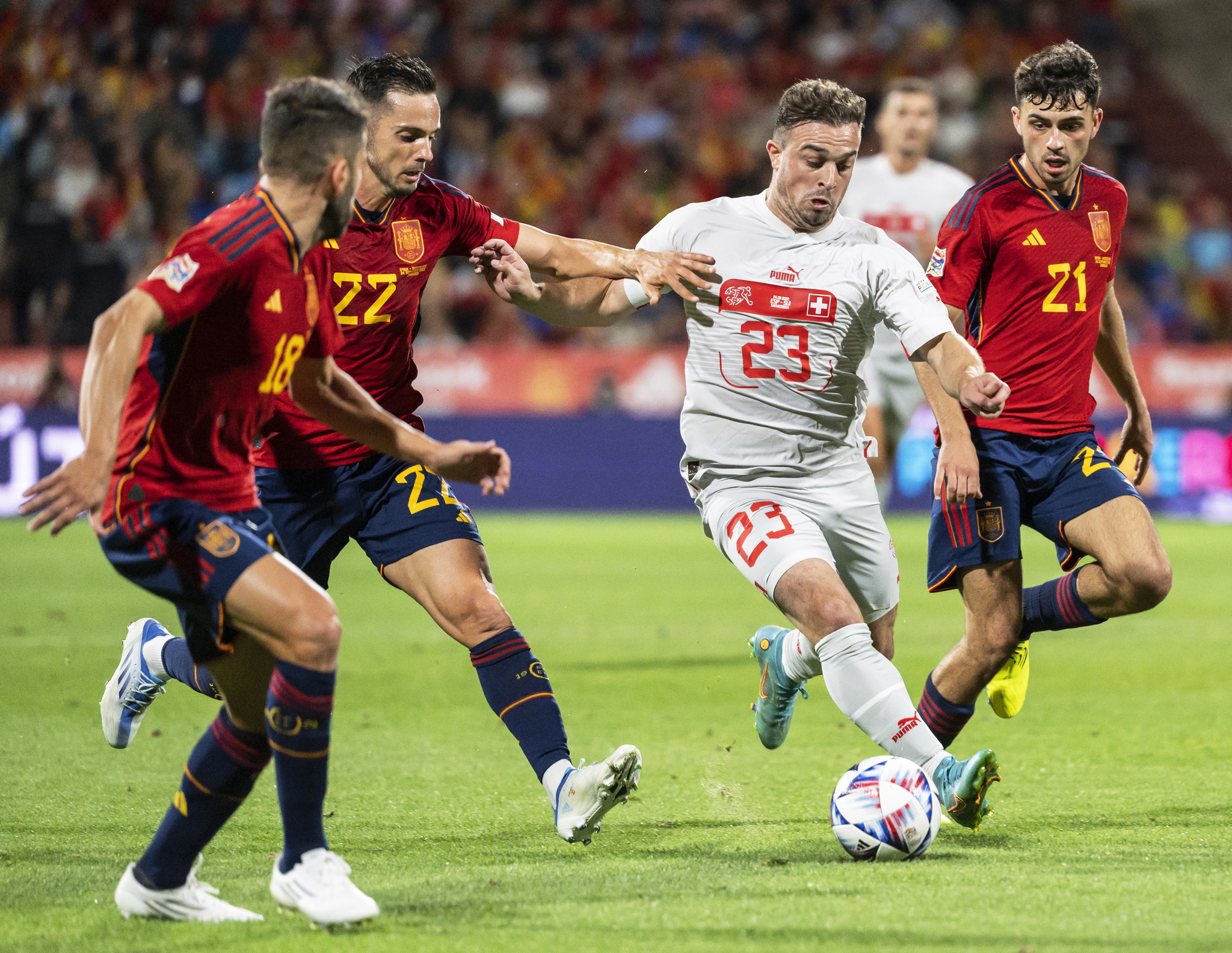 Switzerlands Xherdan Shaqiri in action against Spanish players (L-R) Jordi Alba, Pablo Sarabia, and Pedri