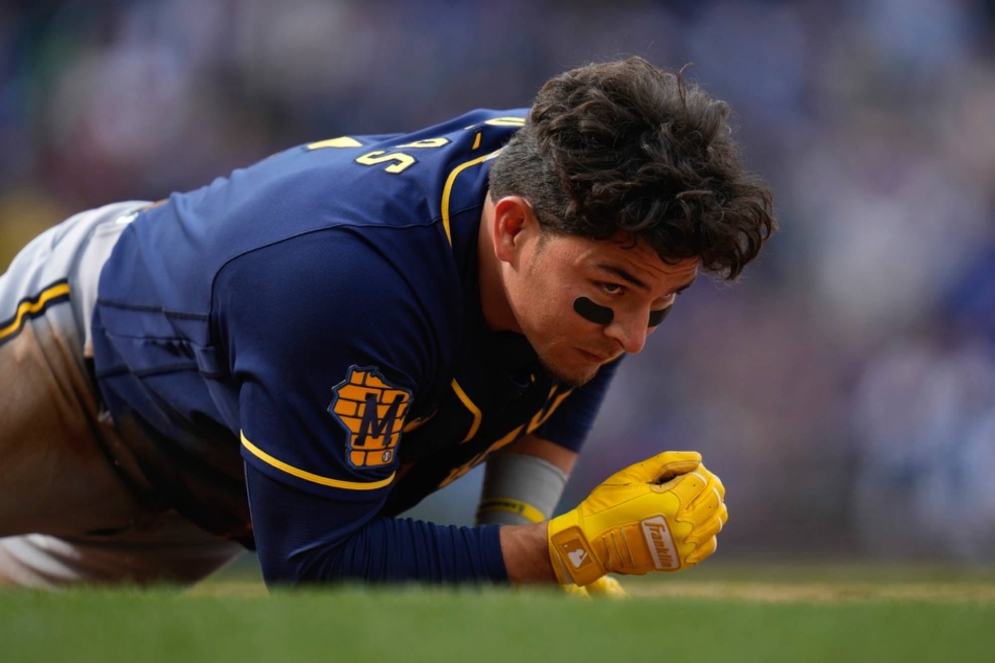 Milwaukee Brewers second baseman Luis Urias gets up after being tagged out at first during the ninth inning of a baseball game against the Chicago Cubs