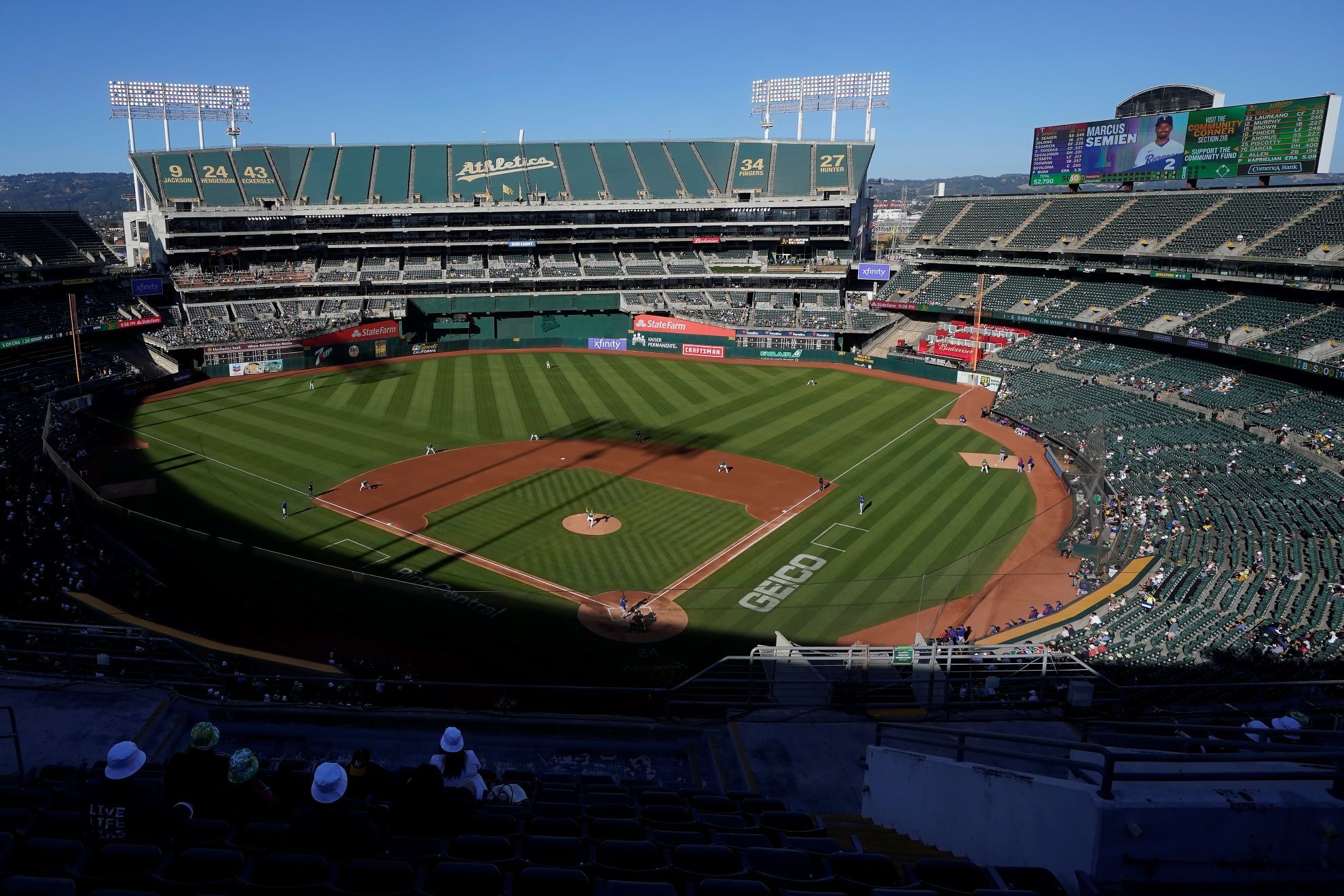 People watch a baseball game at Oakland Coliseum between the Oakland Athletics and the Texas Rangers in Oakland.