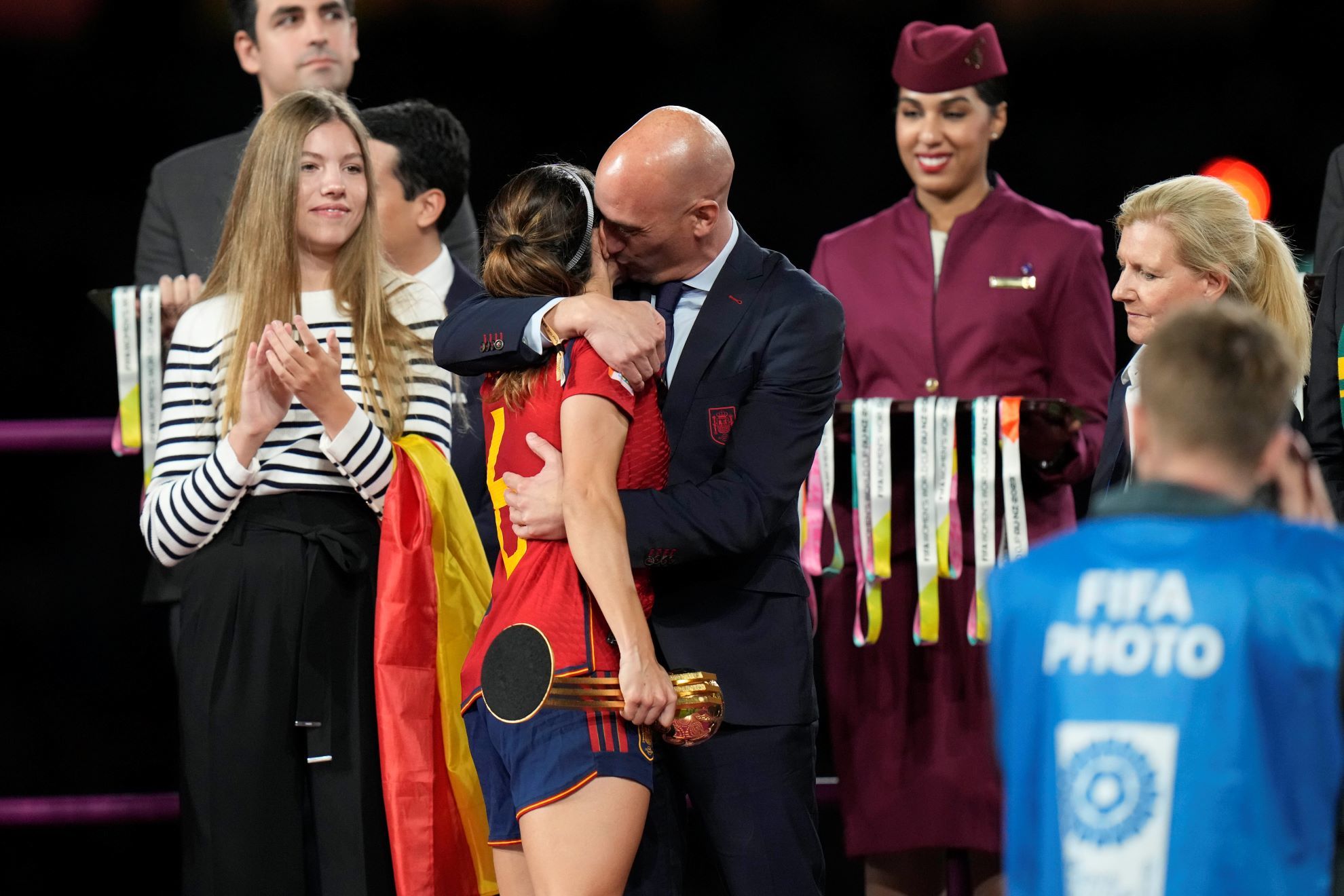 President of Spains soccer federation, Luis Rubiales, right, hugs Spains Aitana Bonmati on the podium.