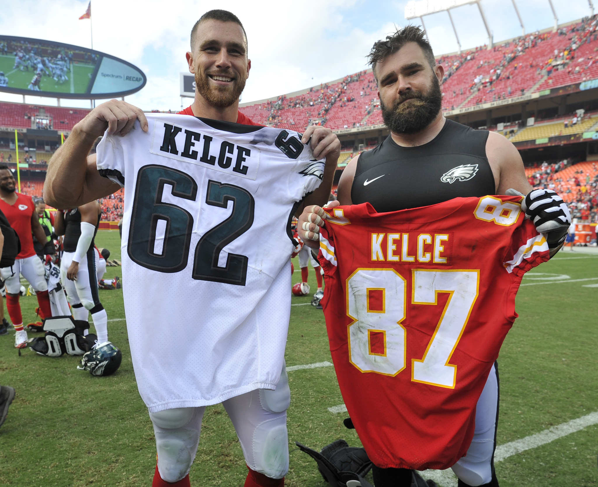 Kansas City Chiefs tight end Travis Kelce, left, and his brother, Philadelphia Eagles center Jason Kelce (62), exchange jerseys