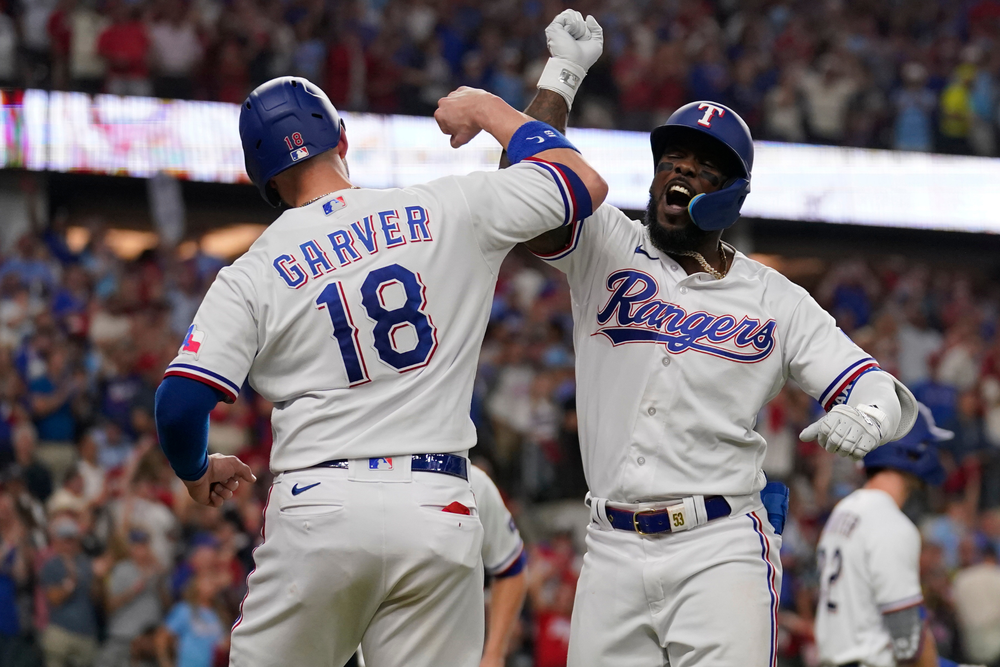 Mitch Garver and Adolis Garcia celebrate the latters home run on Tuesday.