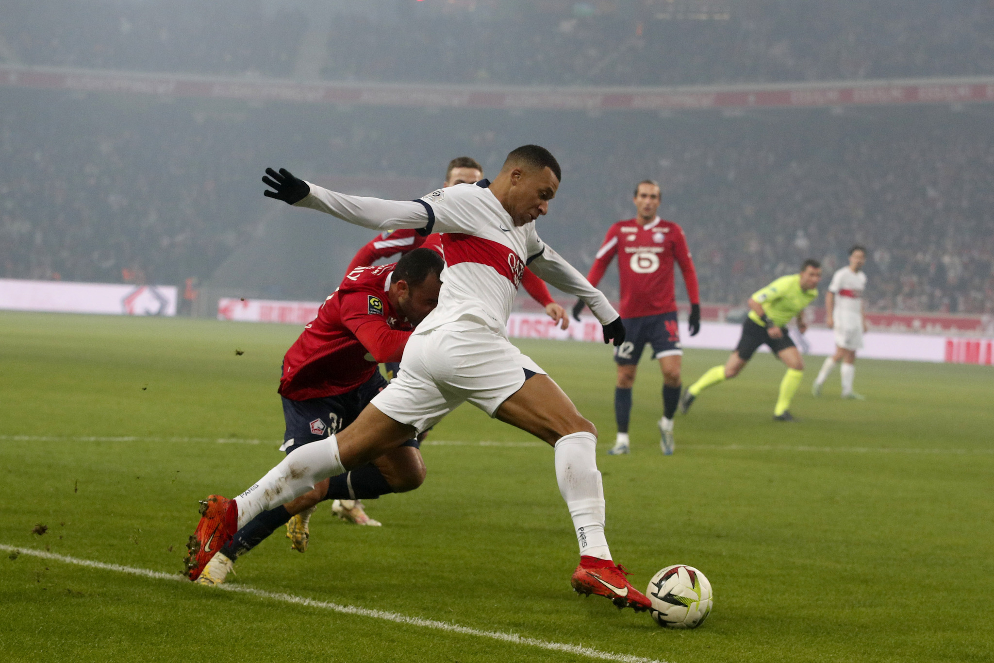 PSGs Kylian Mbappe fights for the ball with Lilles Ismaily