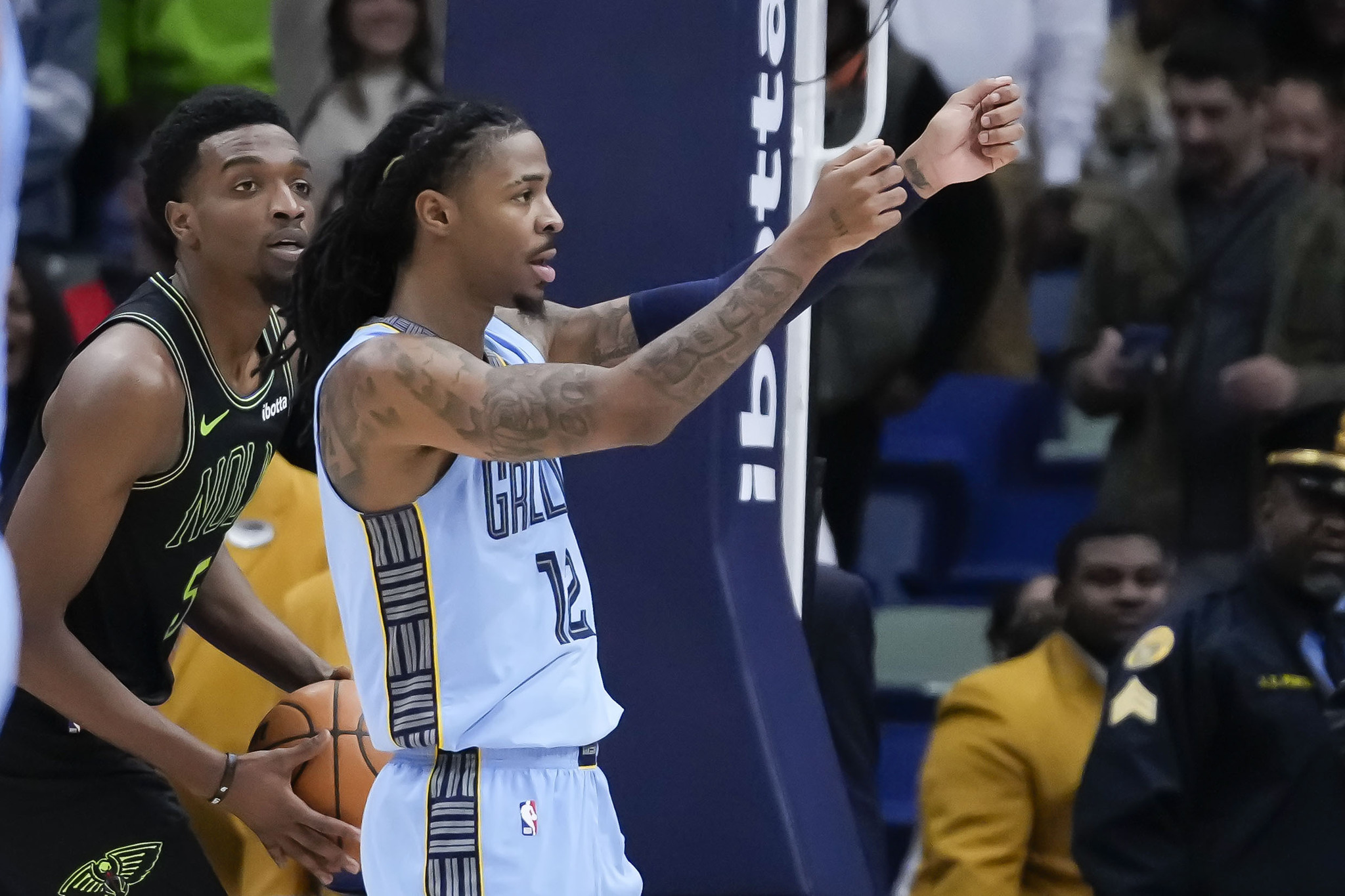 Memphis Grizzlies guard Ja Morant in front of New Orleans Pelicans forward Herbert Jones