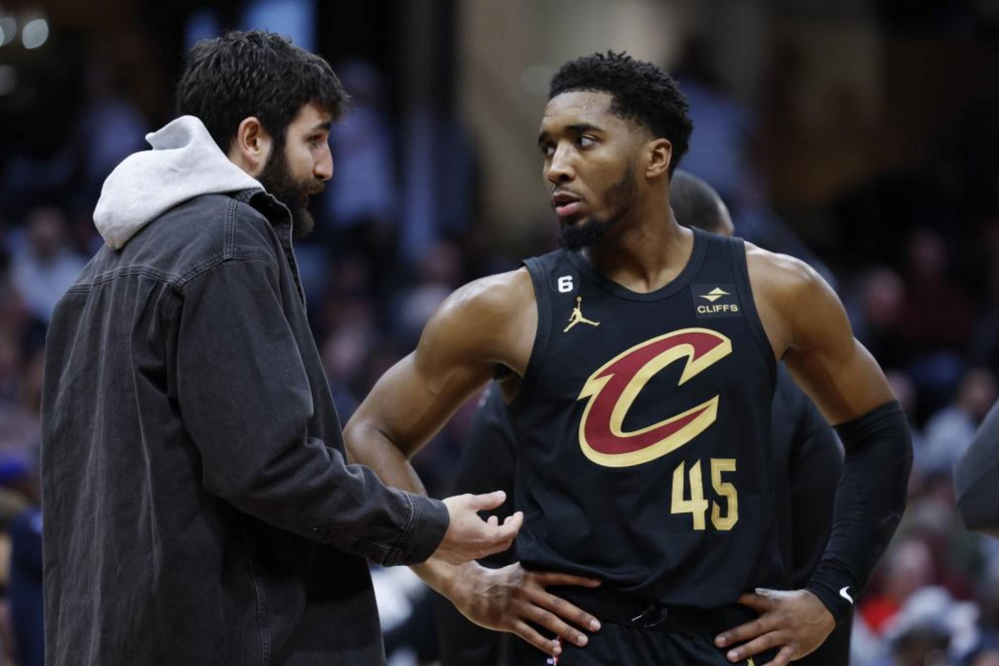 Ricky talks to Donovan Mitchell during an NBA game.