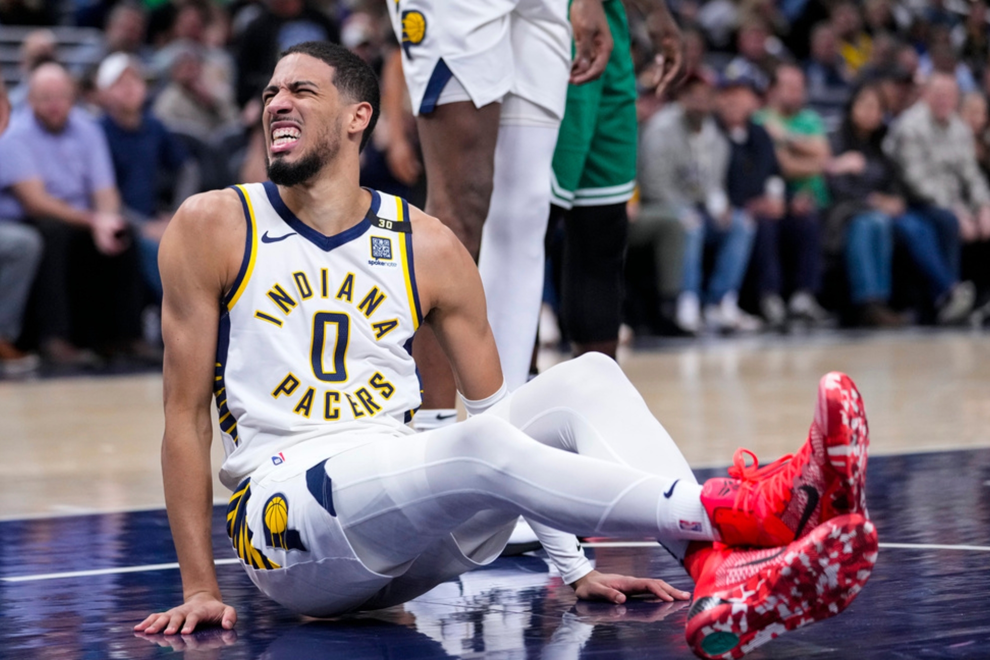 Indiana Pacers guard Tyrese Haliburton (0) reacts after being injured during the first half of an NBA basketball game against the Boston Celtics in Indianapolis, Monday, Jan. 8, 2024. (AP Photo/Michael Conroy)