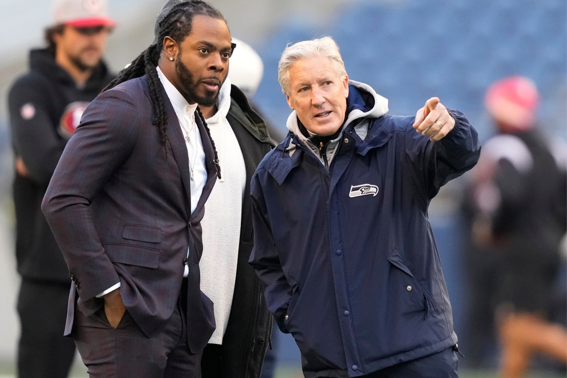 Carroll (right) speaks for former player Richard Sherman (left).