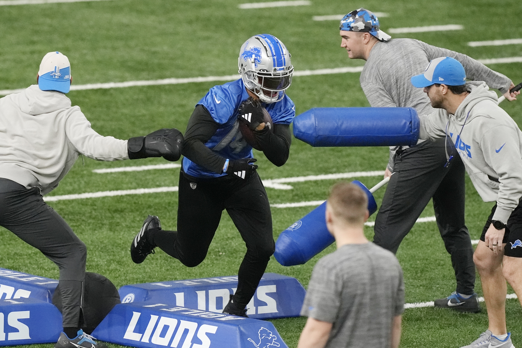 Detroit Lions receiver Amon-Ra St. Brown runs through a drill