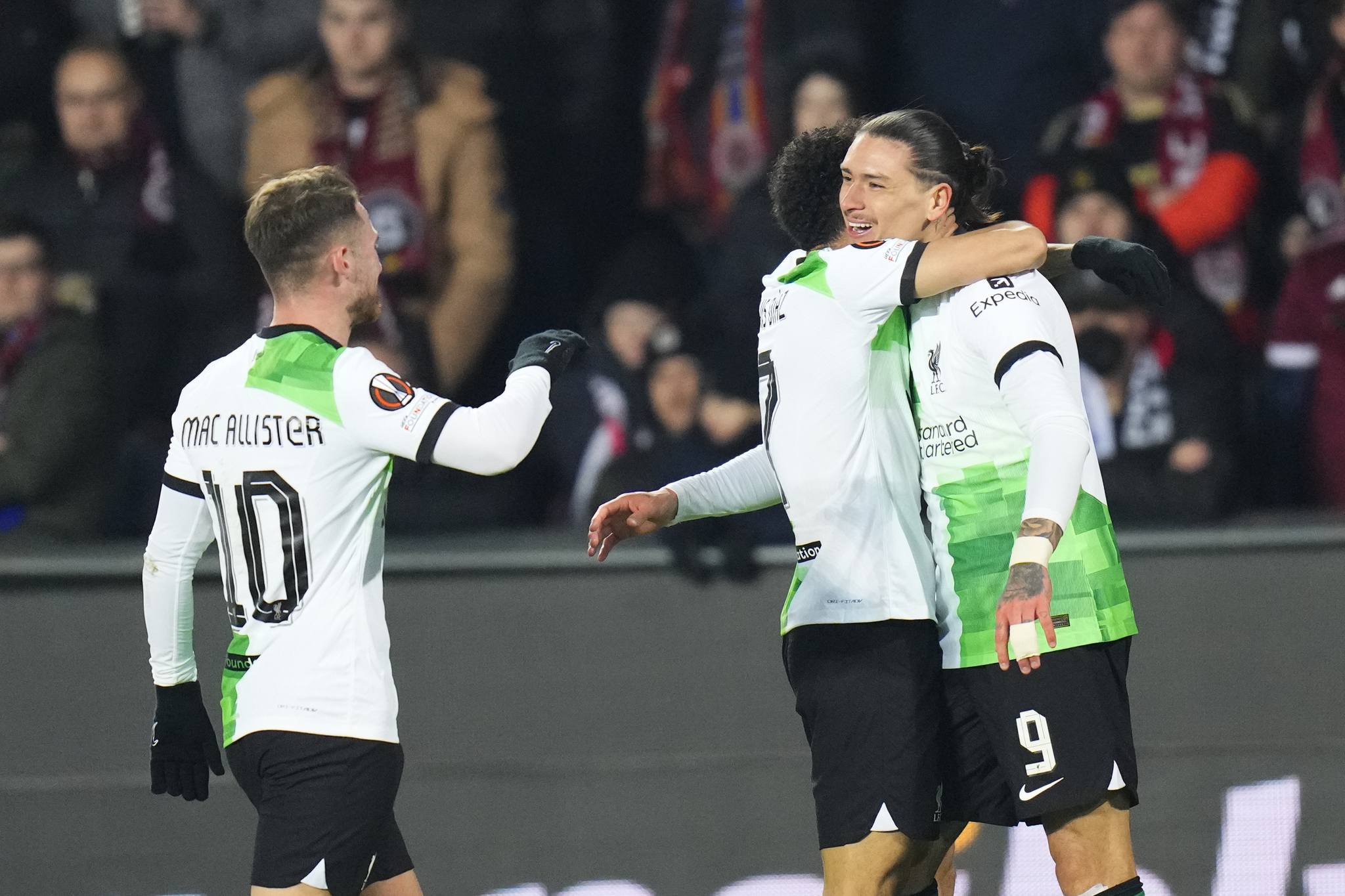 Liverpools Darwin Nunez, right, celebrates with teammates after scoring