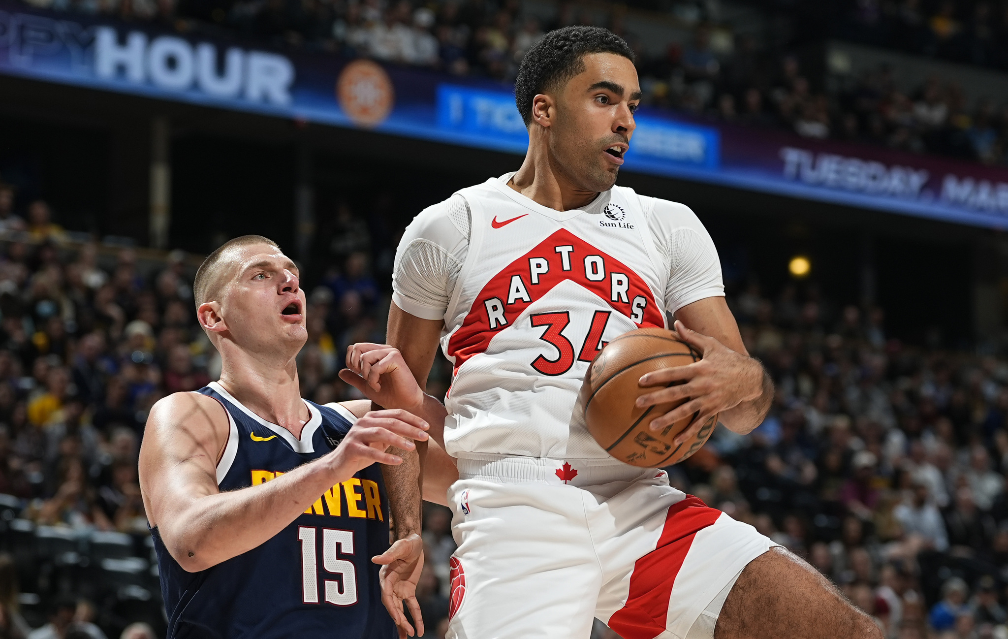 Jontay Porter grabbinga  rebound against Nikola Jokic