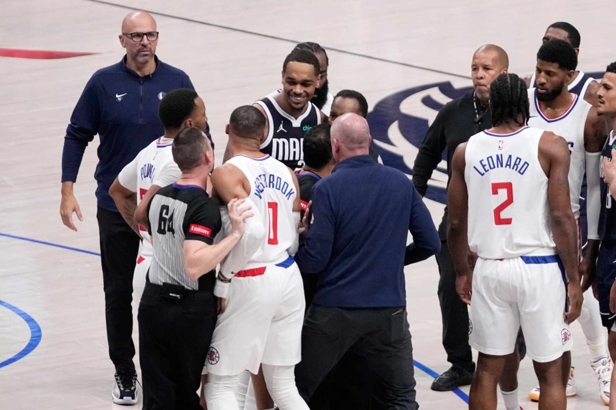 Justin Van Duyne (64) holds Los Angeles Clippers Russell Westbrook (0) back and another holds Dallas Mavericks P.J. Washington /