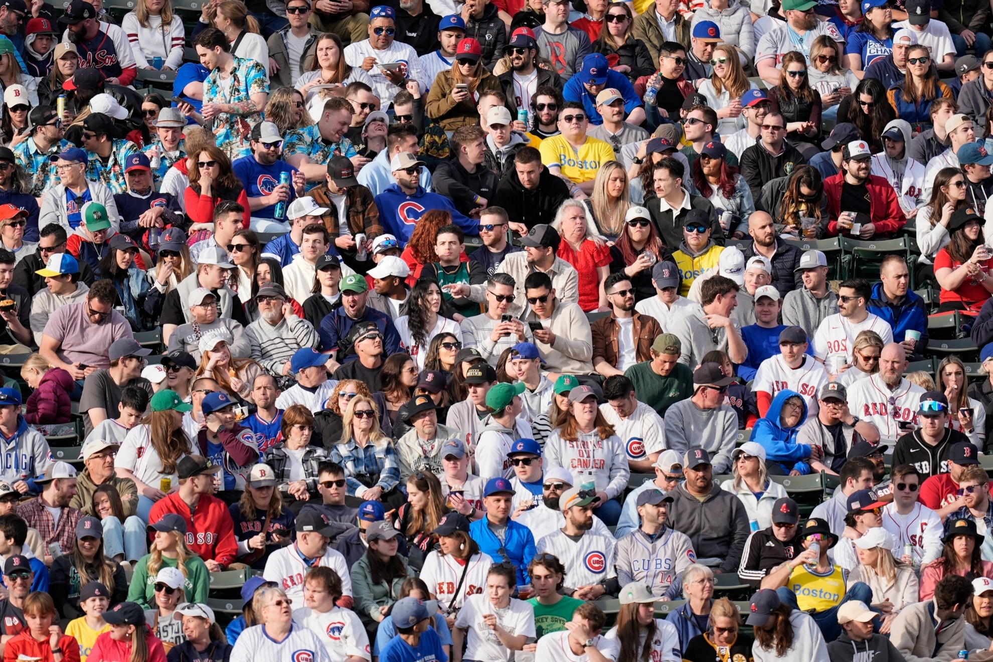 Fans in the bleachers at Fenway Park during the seventh inning of a baseball game between the Boston Red Sox and the Chicago Cubs, Saturday, April 27, 2024, in Boston. (AP Photo/Michael Dwyer)