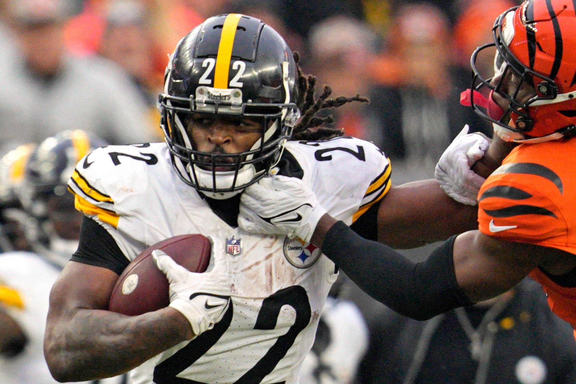 Pittsburgh Steelers running back Najee Harris (22) stiff arms Cincinnati Bengals cornerback Chidobe Awuzie (22) during the second half of an NFL football game in Cincinnati, Sunday, Nov. 26, 2023. The Steelers won 16-10. (AP Photo/Jeffrey Dean)