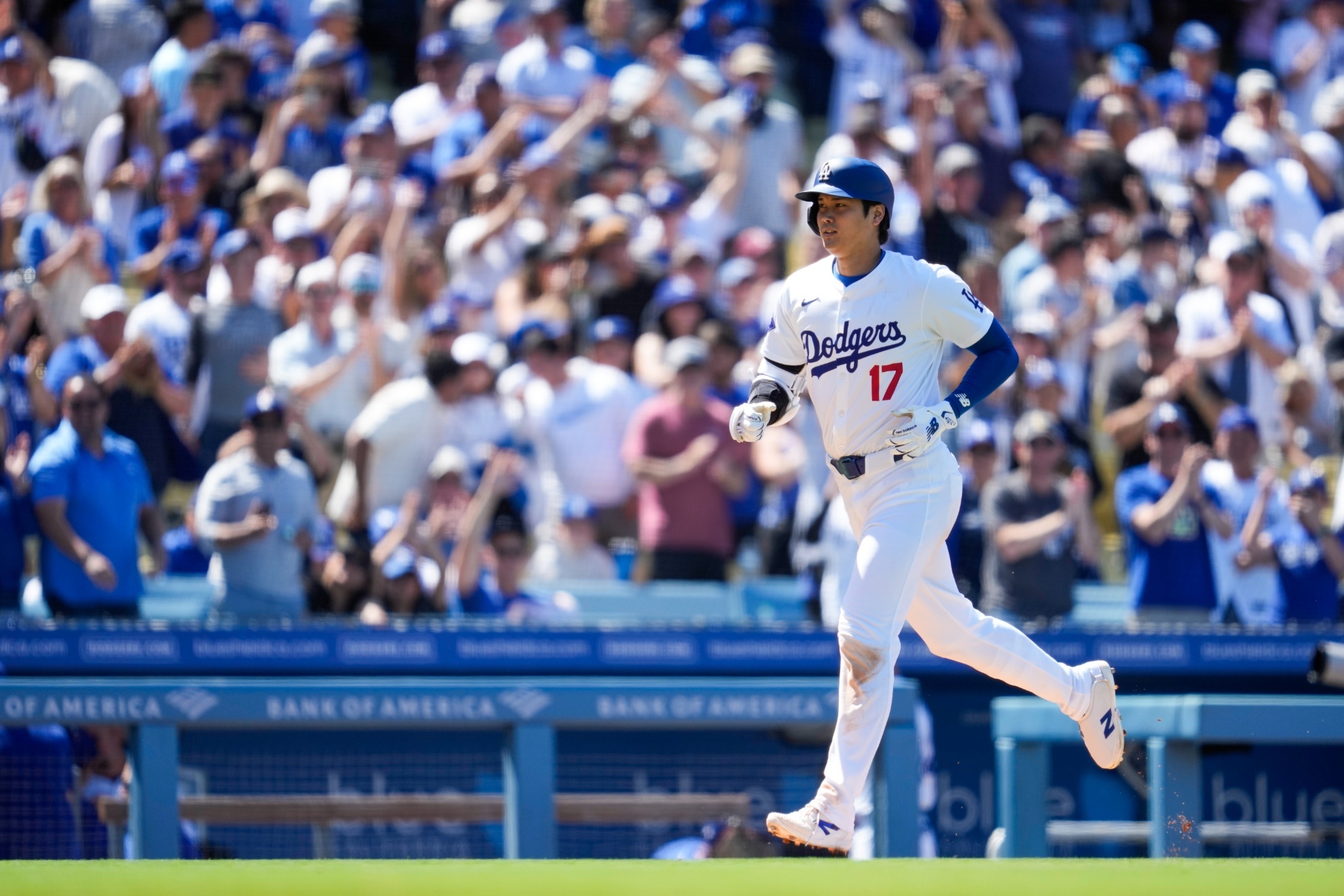 Los Angeles Dodgers designated hitter Shohei Ohtani runs the bases after hitting a home run during the eighth inning of a baseball game against the Atlanta Braves in Los Angeles, Sunday, May 5, 2024. (AP Photo/Ashley Landis)