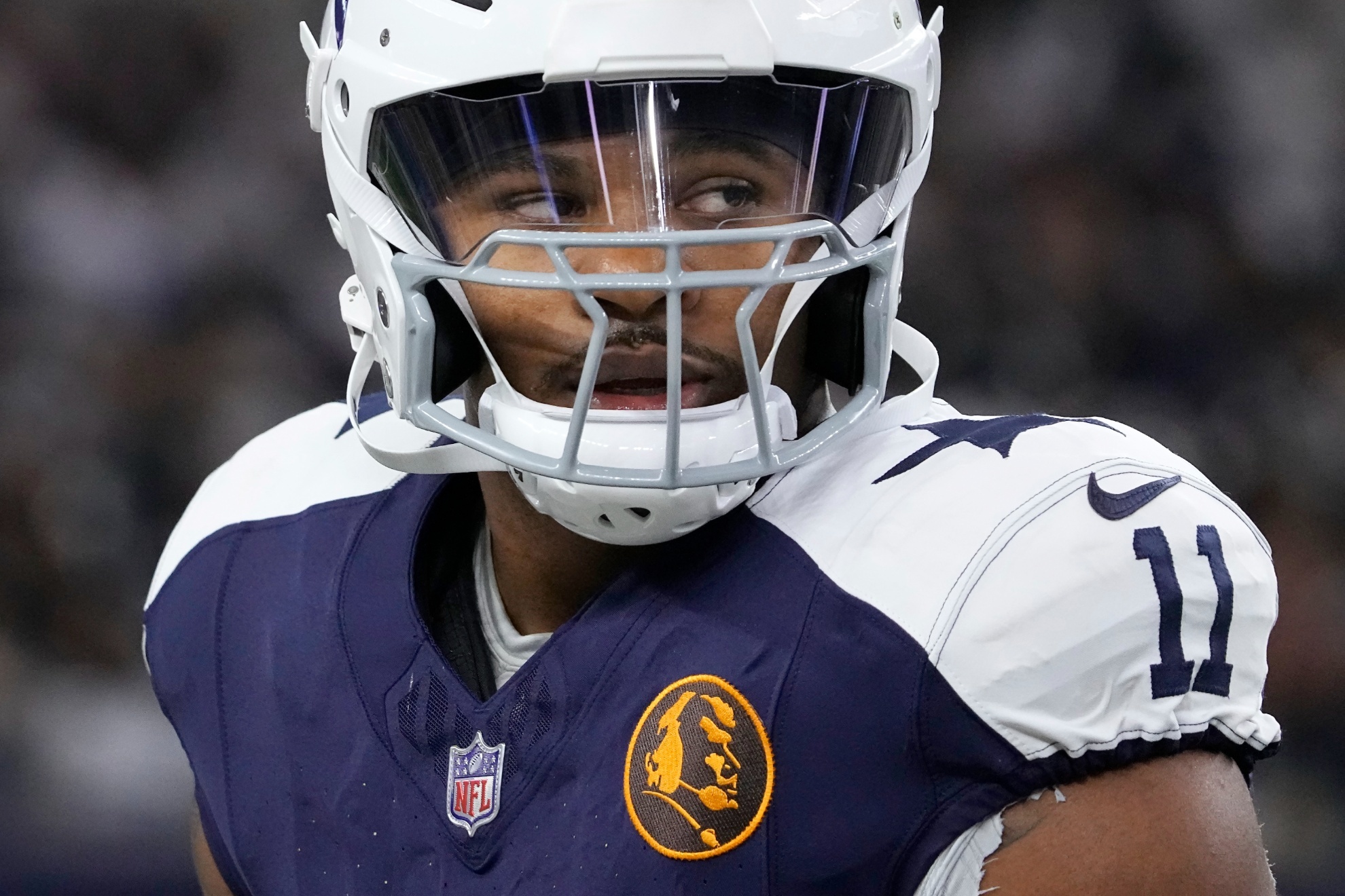 A John Madden logo is shown on the jersey of Dallas Cowboys linebacker Micah Parsons as he warms up before an NFL football game against the Washington Commanders Thursday, Nov. 23, 2023, in Arlington, Texas. (AP Photo/Sam Hodde)