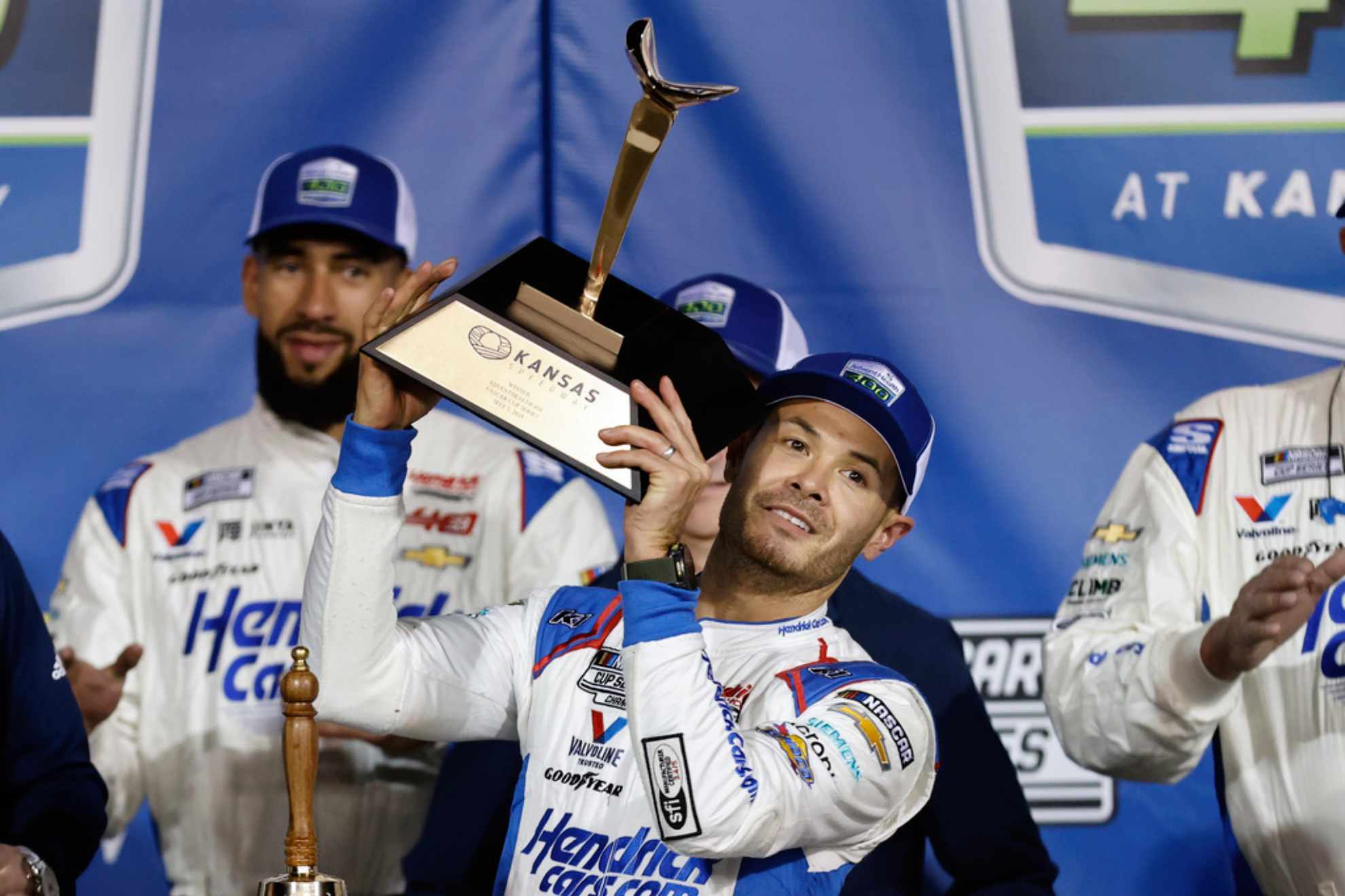 Kyle Larson, center, celebrates in Victory Lane after winning a NASCAR Cup Series auto race at Kansas Speedway /