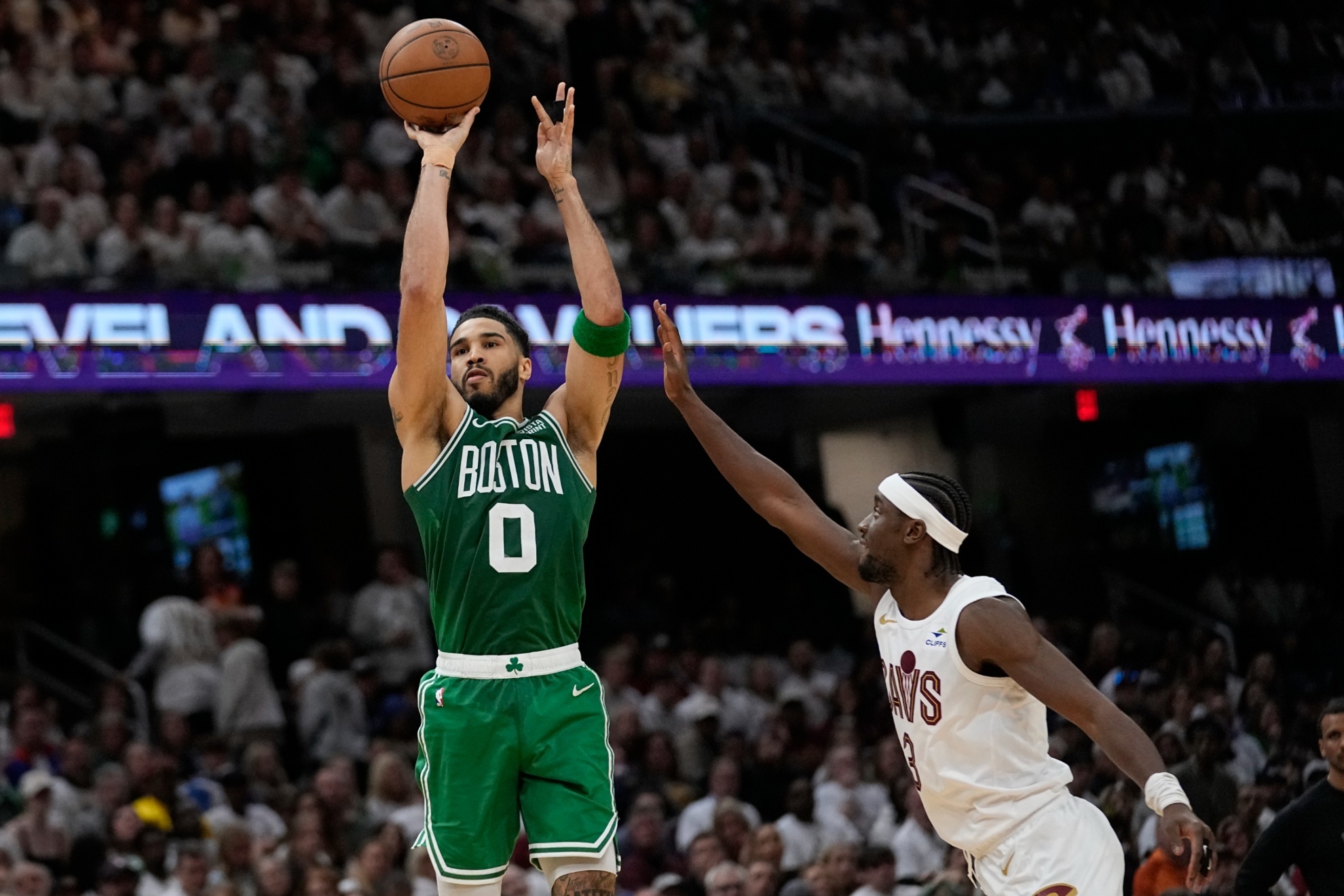 Boston Celtics forward Jayson Tatum (0) shoots in front of Cleveland Cavaliers guard Caris LeVert during the second half of Game 3 of an NBA basketball second-round playoff series Saturday, May 11, 2024, in Cleveland. (AP Photo/Sue Ogrocki)