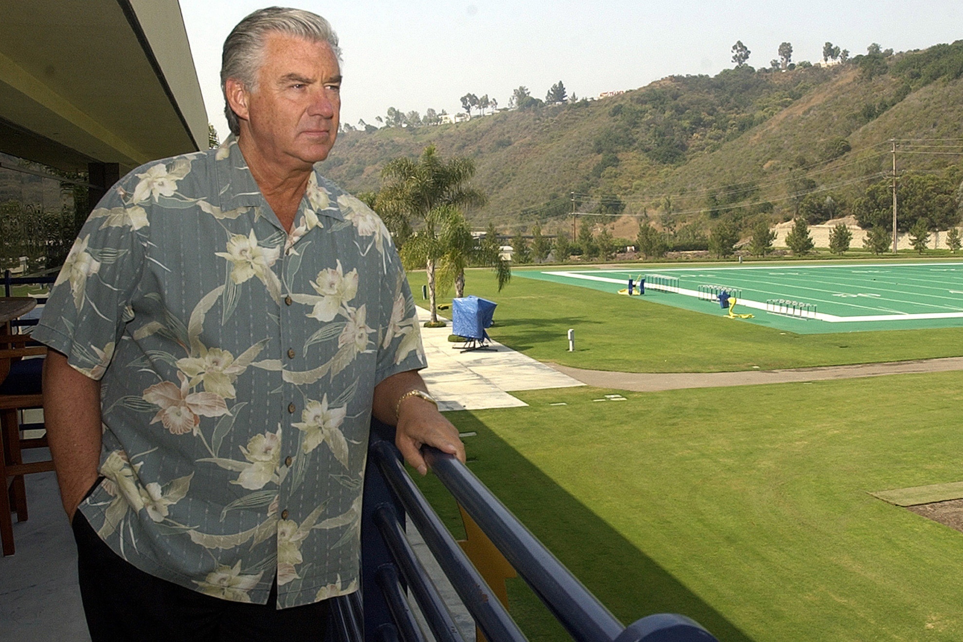 San Diego Chargers General Manager A.J. Smith stares out at the Chargers practice fields from his office balcony Wednesday, July 9, 2003, in San Diego. Smith, a longtime assistant to the late John Butler, is preparing for his first season as an NFL general manager. (AP Photo/Lenny Ignelzi)