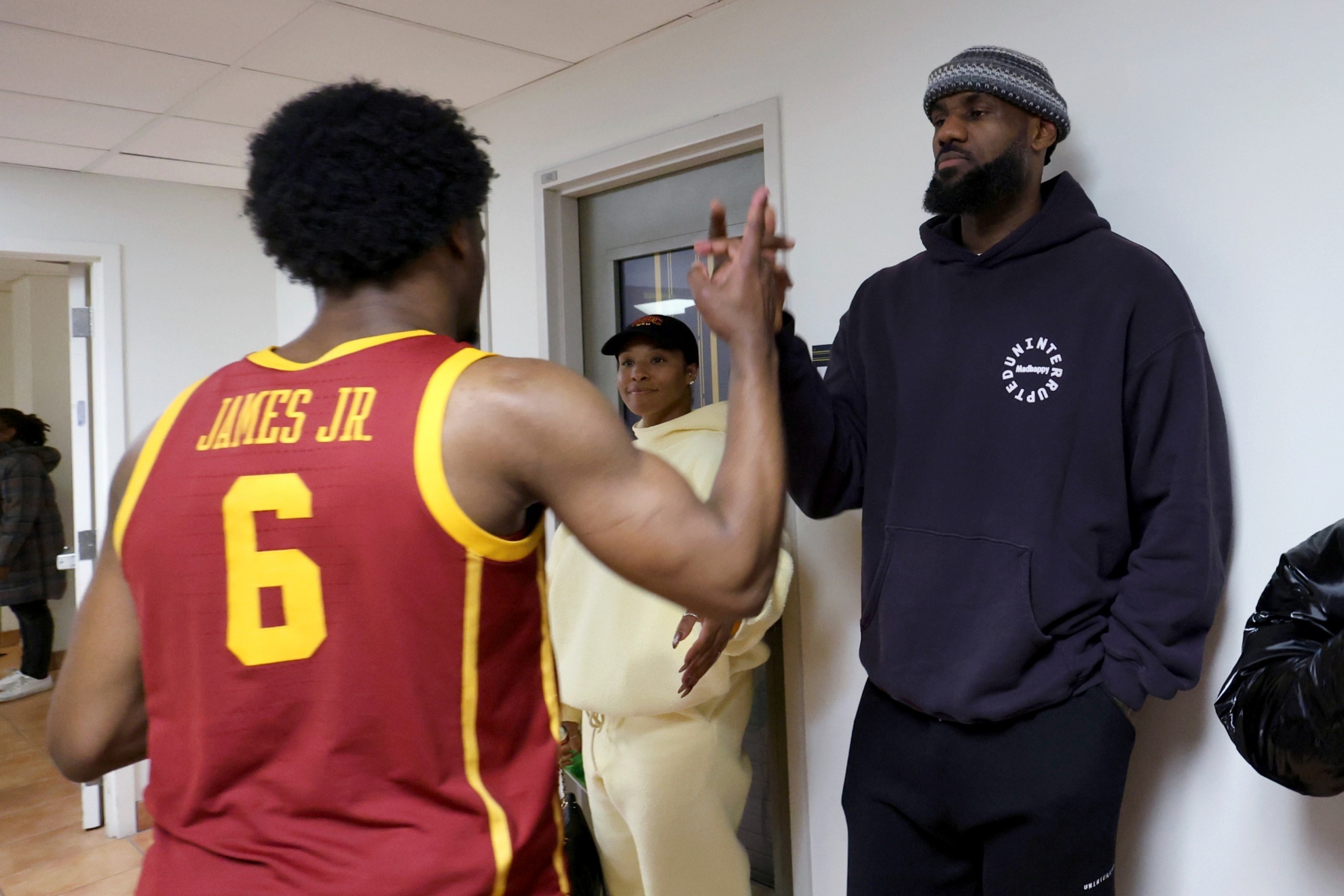 Southern California guard Bronny James (6) greets his father, Los Angeles Lakers LeBron James, after the teams NCAA college basketball game against California in Berkeley, Calif., Wednesday, Feb. 7, 2024. (AP Photo/Jed Jacobsohn)