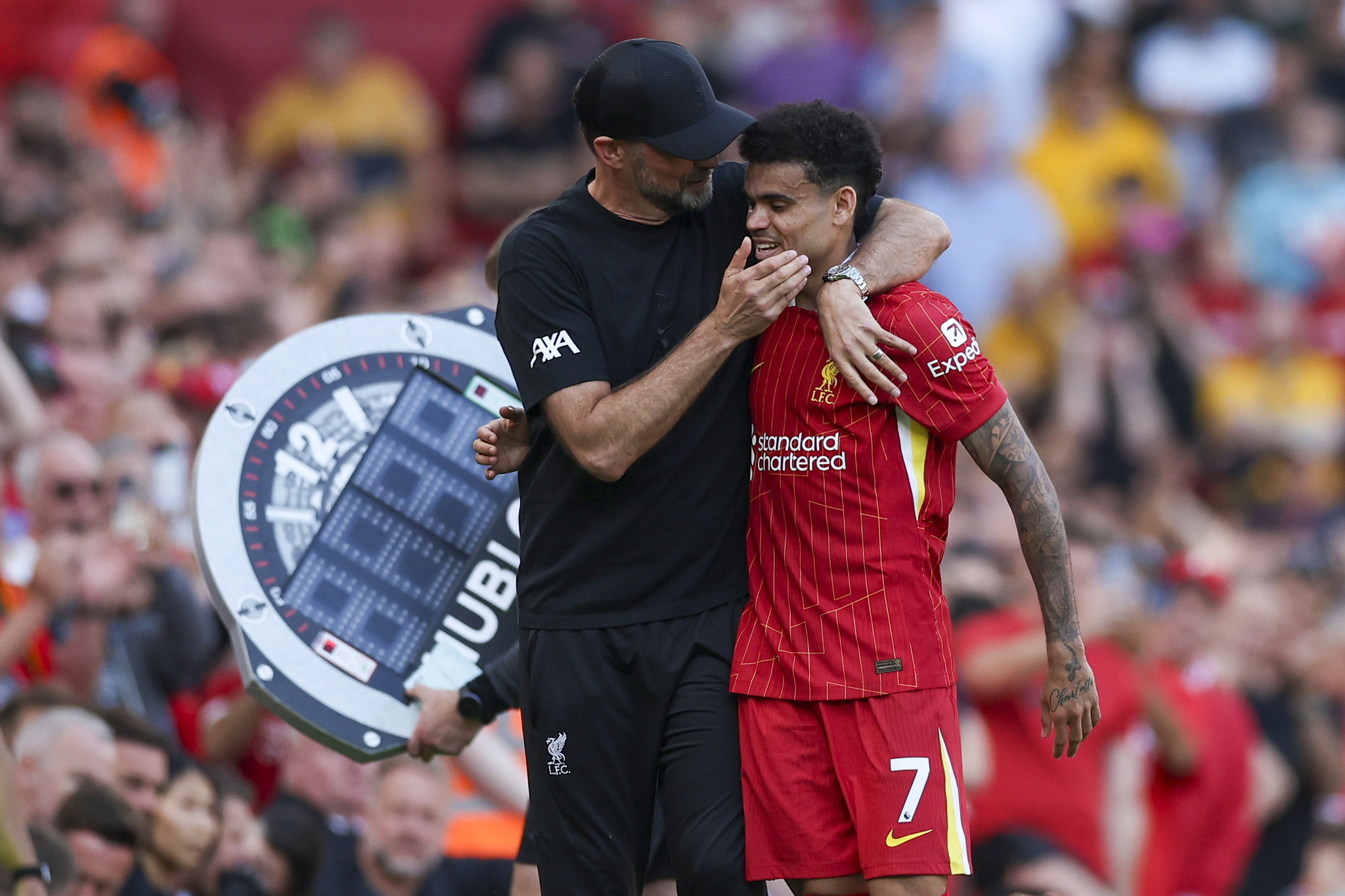 Liverpool manager Jurgen Klopp (L) hugs Luis Diaz