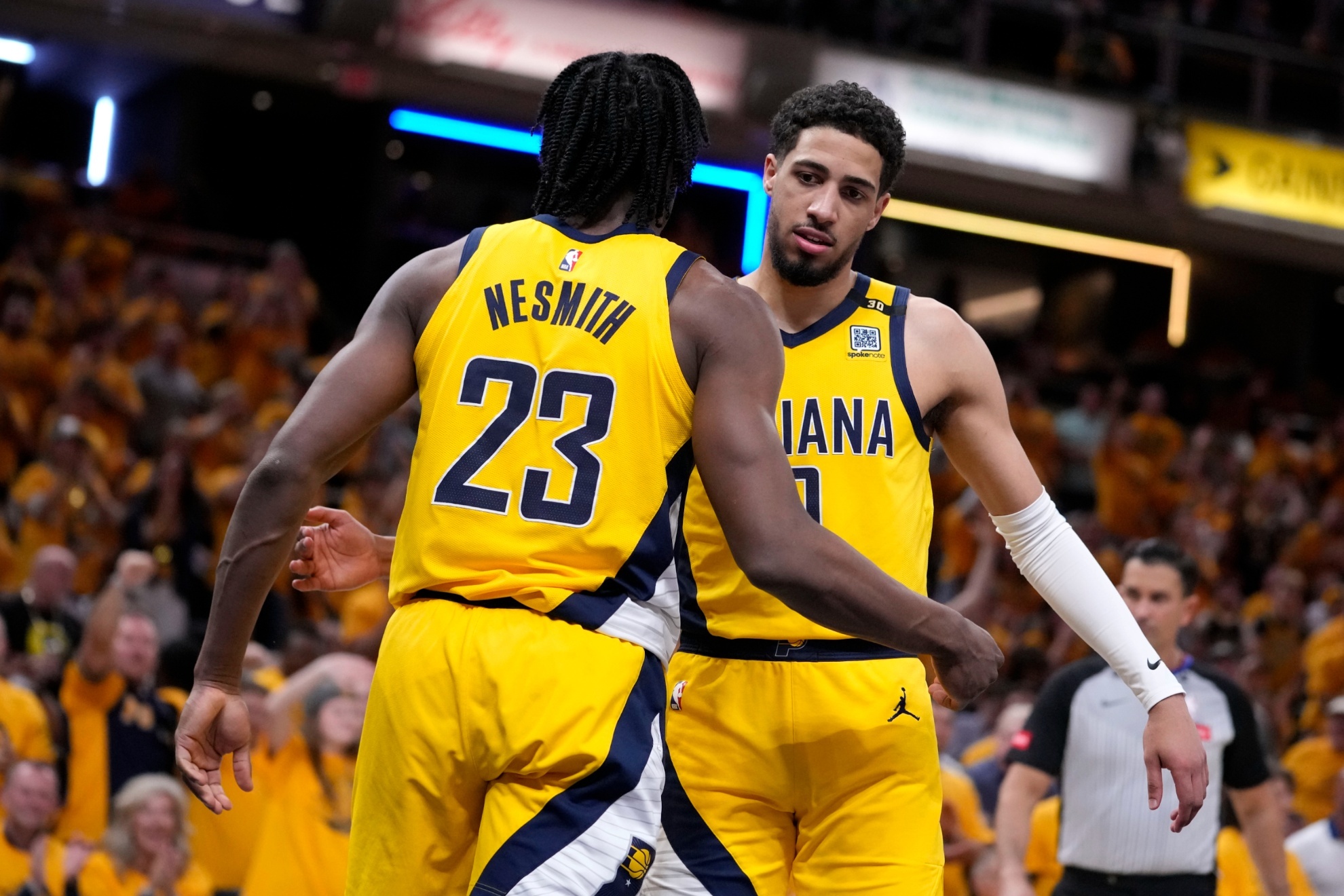 Indiana Pacers forward Aaron Nesmith (23) celebrates with teammate guard Tyrese Haliburton after a dunk during the second half of Game 6 against the New York Knicks in an NBA basketball second-round playoff series, Friday, May 17, 2024, in Indianapolis. (AP Photo/Michael Conroy)