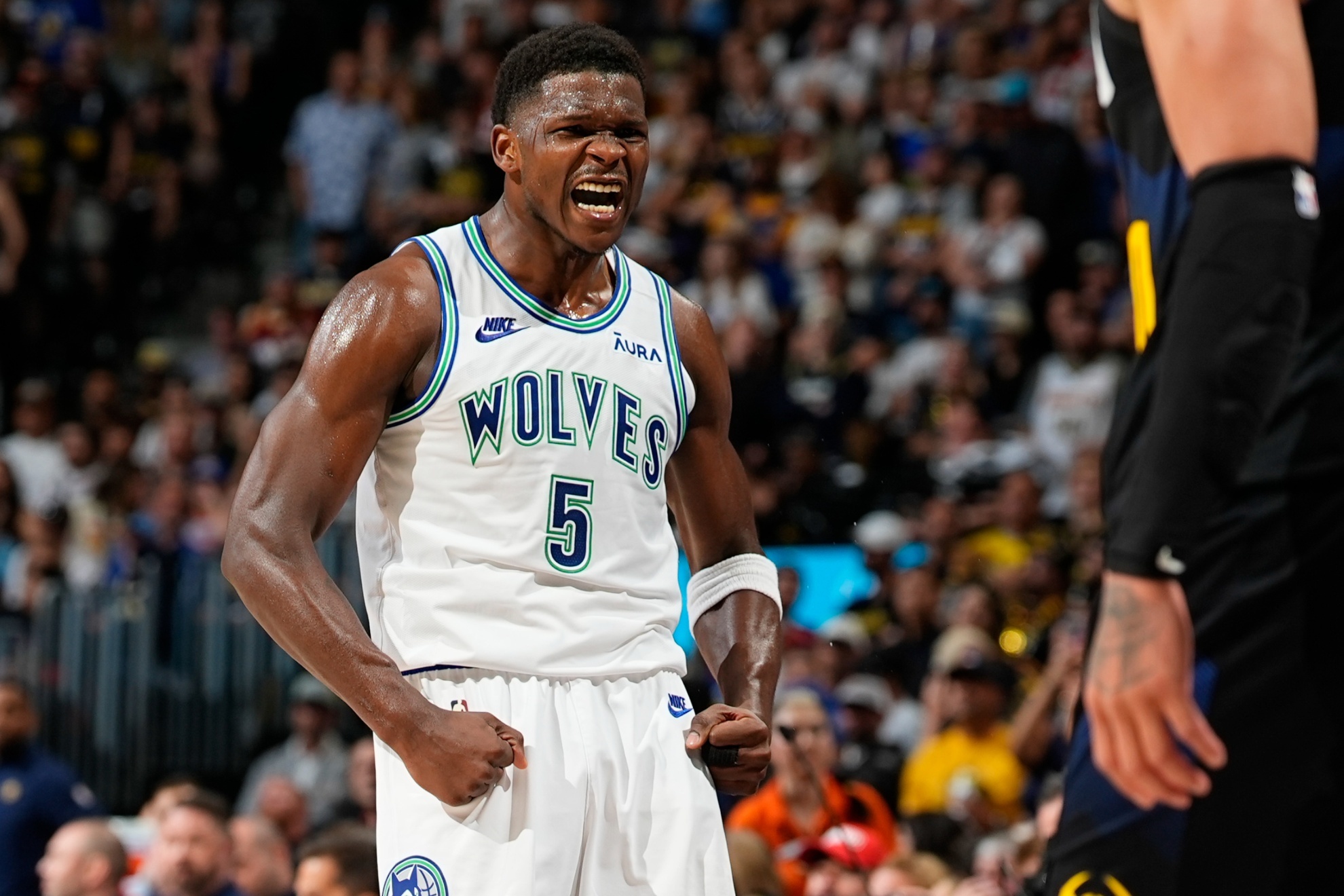 Minnesota Timberwolves guard Anthony Edwards reacts after hitting a basket over Denver Nuggets forward Aaron Gordon in the second half of Game 7 of an NBA second-round playoff series, Sunday, May 19, 2024, in Denver. (AP Photo/David Zalubowski)