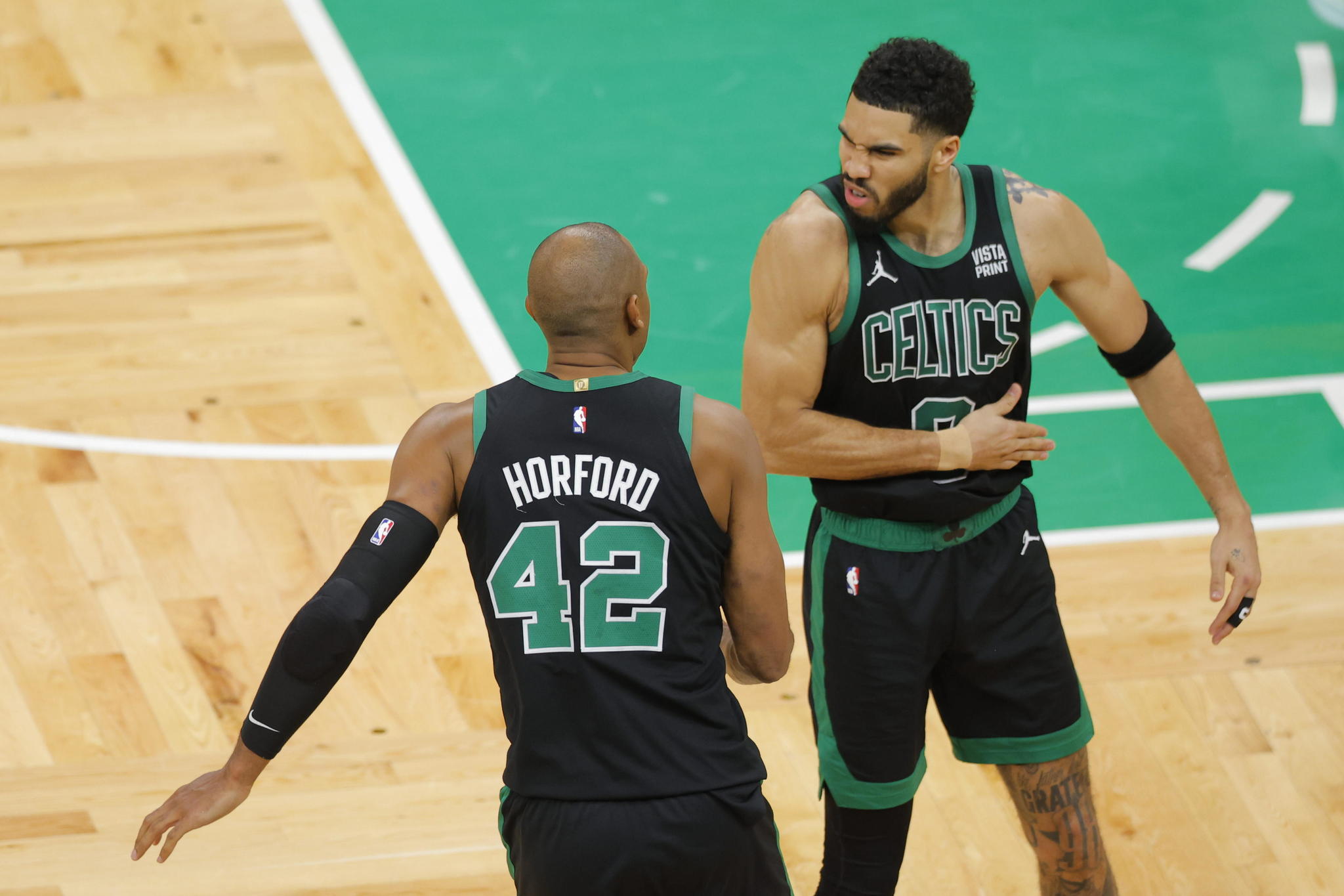 Celtics center Al Horford (L) and forward Jayson Tatum celebrate