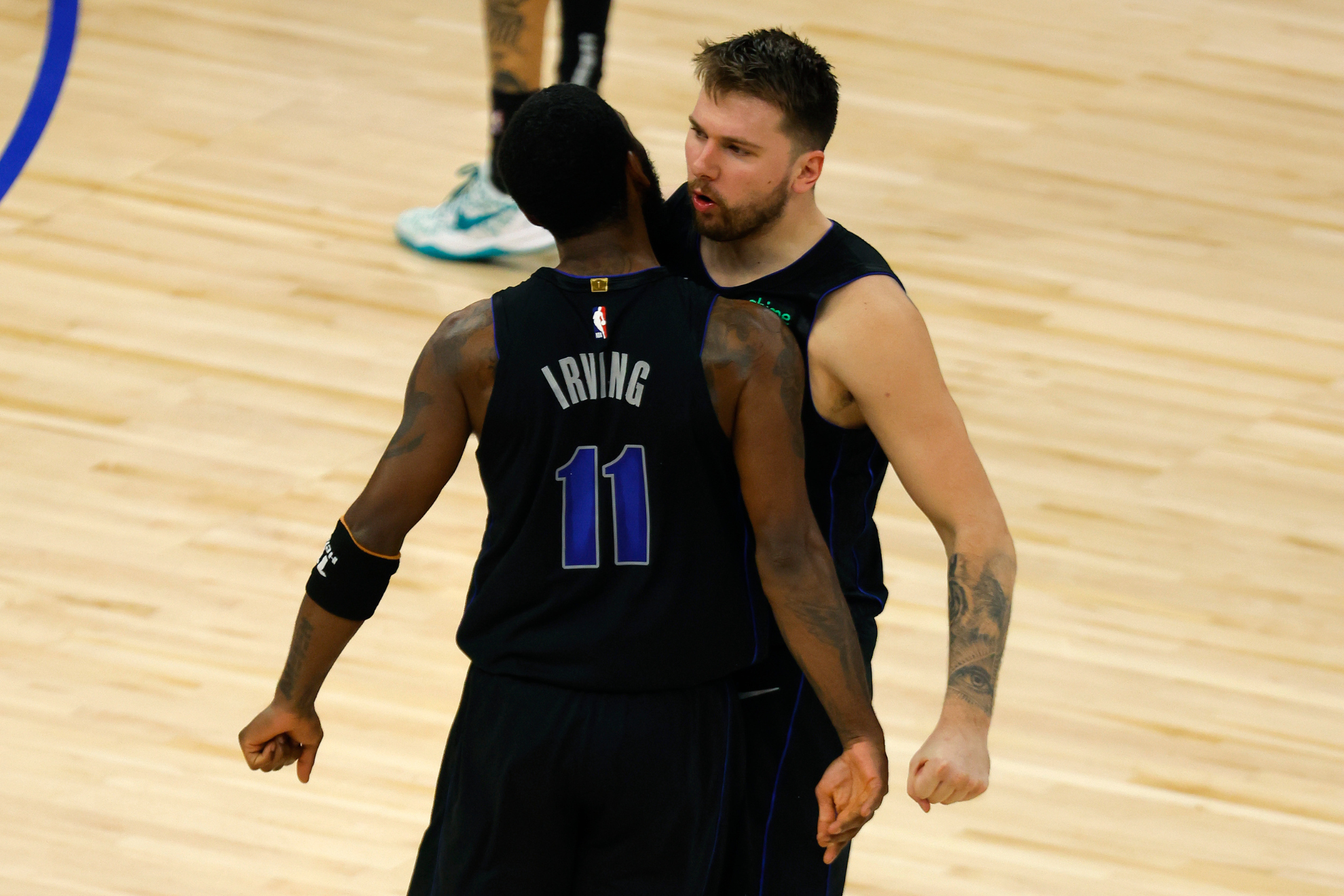 Luka Doncic celebrates his game-winning shot with Kyrie Irving.