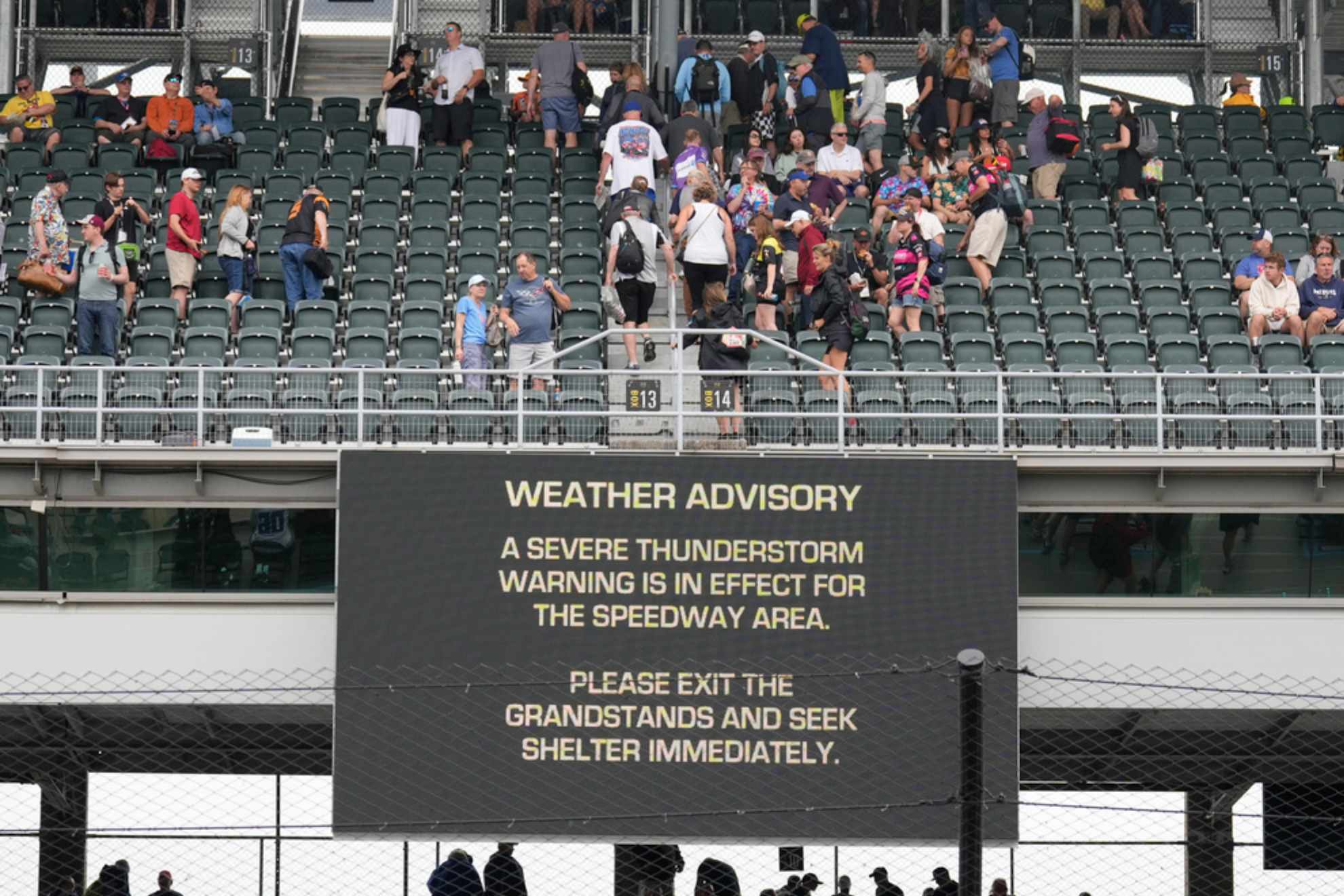 Fans exit the grandstands after a serve thunderstorm warning was issued for the area around the Indianapolis 500 auto race /