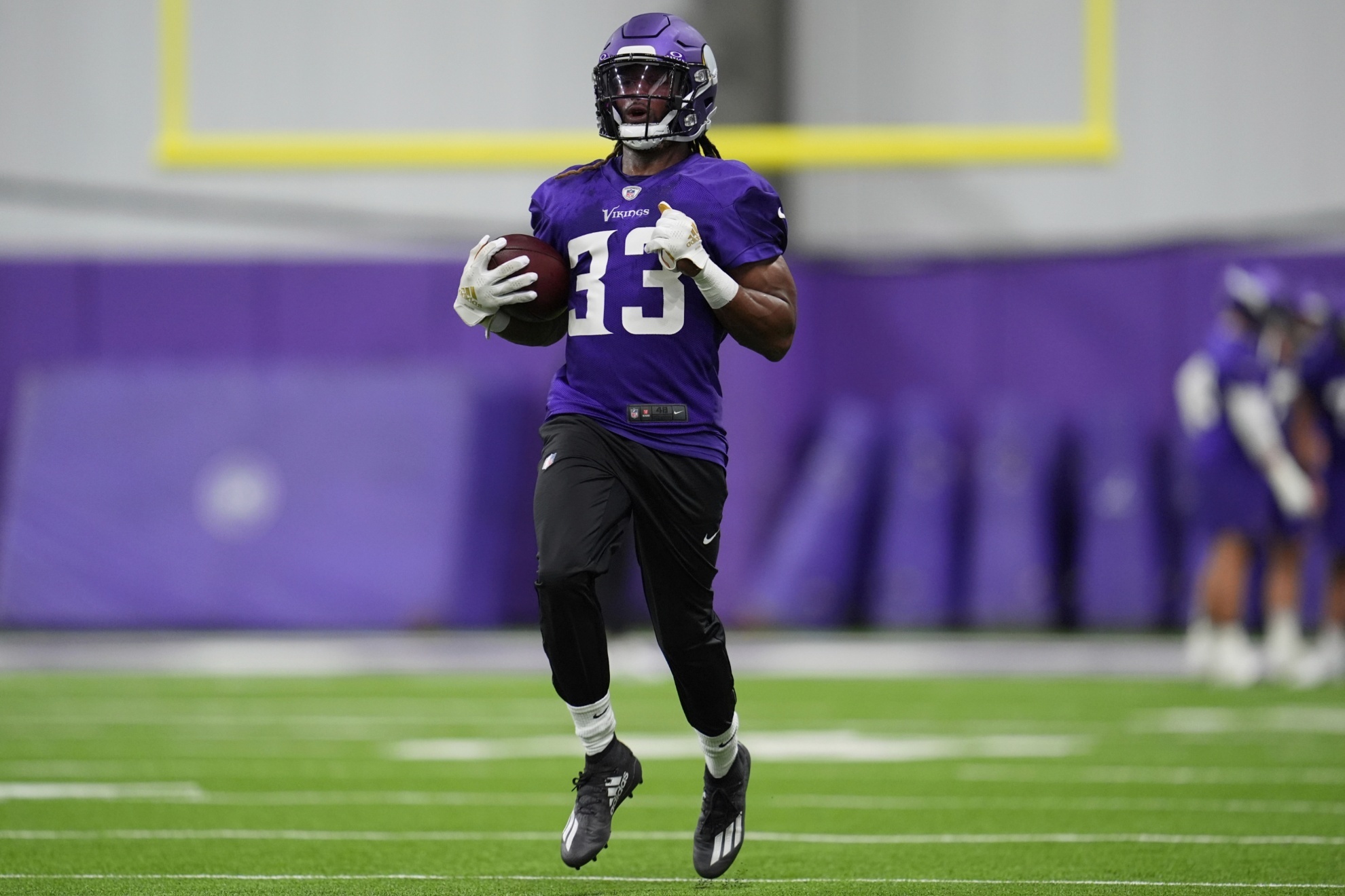 Minnesota Vikings running back Aaron Jones (33) takes part in drills during NFL football practice in Eagan, Minn., Tuesday, May 21, 2024. (AP Photo/Abbie Parr)