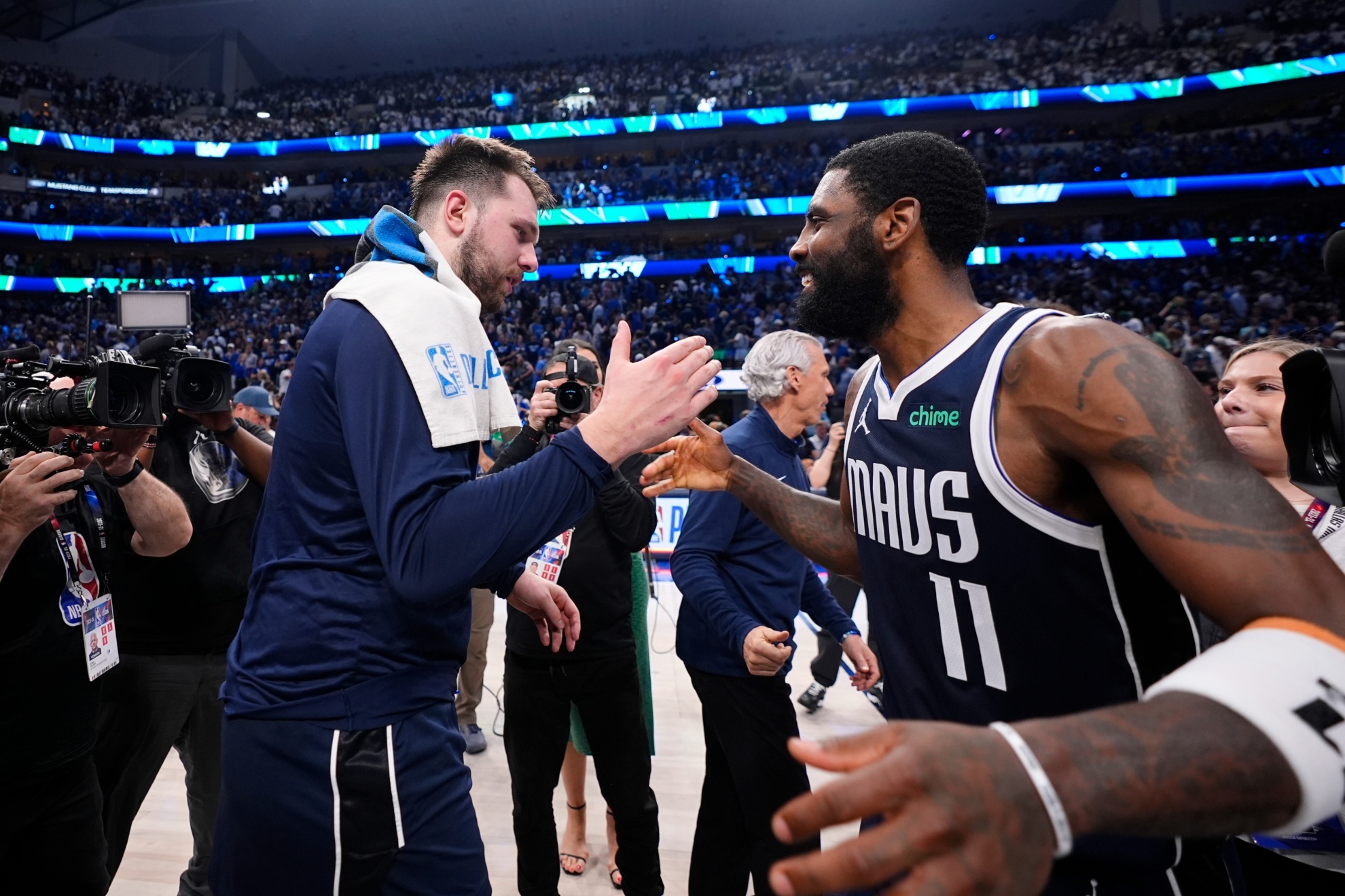 Dallas Mavericks guard Luka Doncic, left, and Dallas Mavericks guard Kyrie Irving (11) celebrate their win over the Minnesota Timberwolves in Game 3 of the NBA basketball Western Conference finals, Sunday, May 26, 2024, in Dallas. (AP Photo/Julio Cortez)