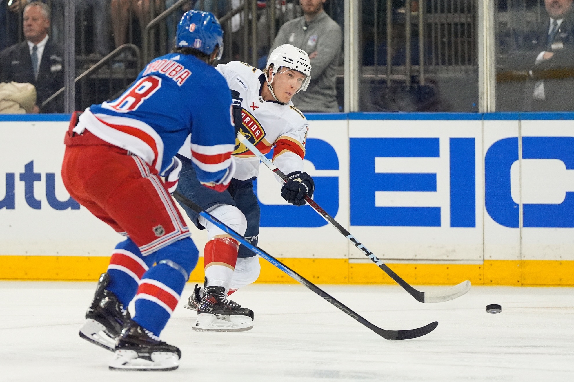 Florida Panthers center Anton Lundell (15) passes the puck against New York Rangers defenseman Jacob Trouba (8) during the first period of Game 1 of the NHL hockey Eastern Conference Stanley Cup playoff finals, Wednesday, May 22, 2024, in New York. (AP Photo/Julia Nikhinson)