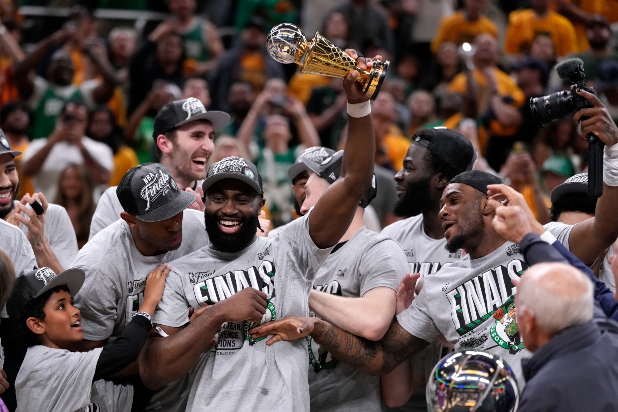 Boston Celtics guard Jaylen Brown, center, celebrates with his teammates after Game 4 of the NBA Eastern Conference basketball finals against the Indiana Pacers, Monday, May 27, 2024, in Indianapolis. The Celtics won 105-102.(AP Photo/Michael Conroy)