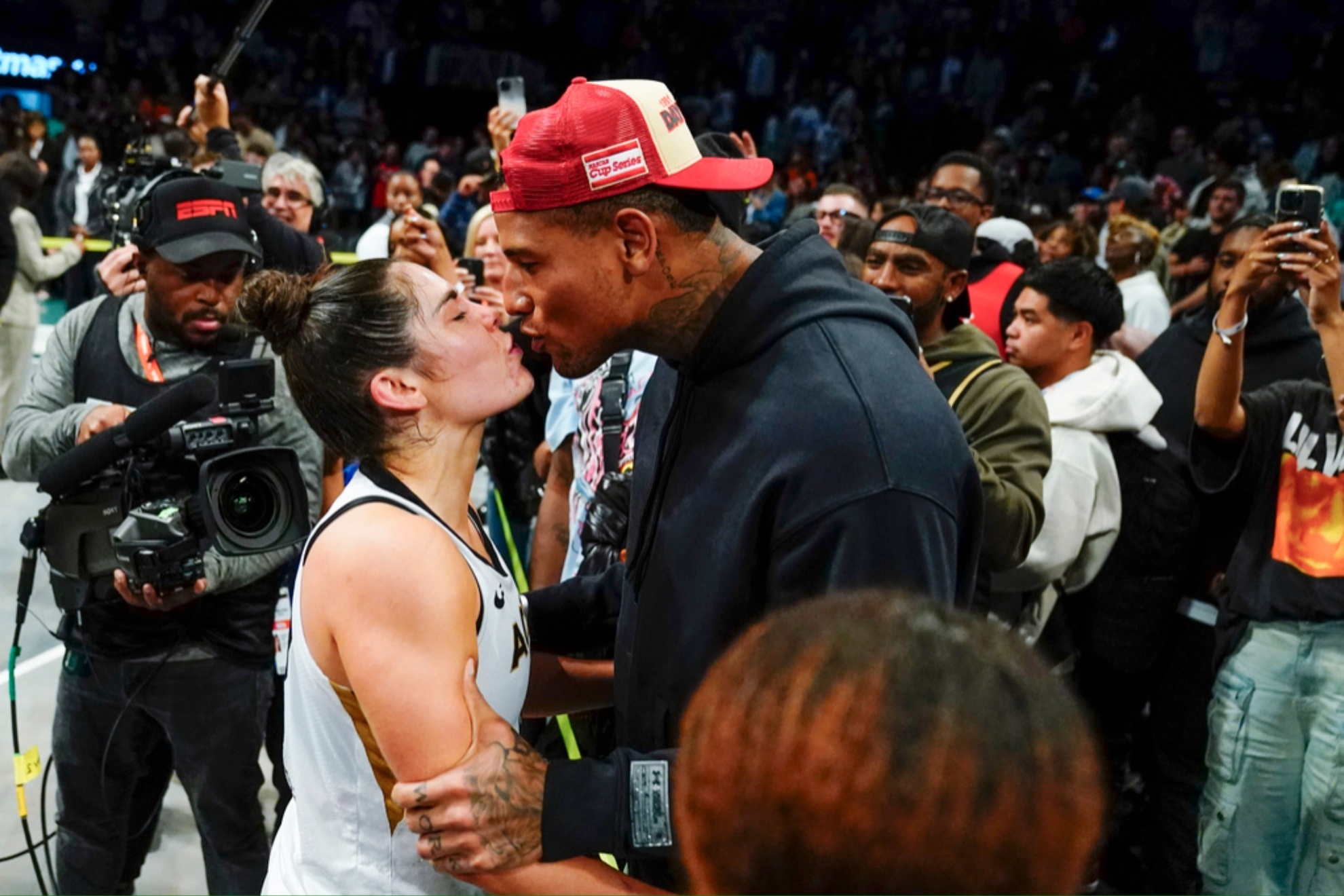 Kelsey Plum (L) kisses Darren Waller after Game 4 of a WNBA 2023 final playoff series.