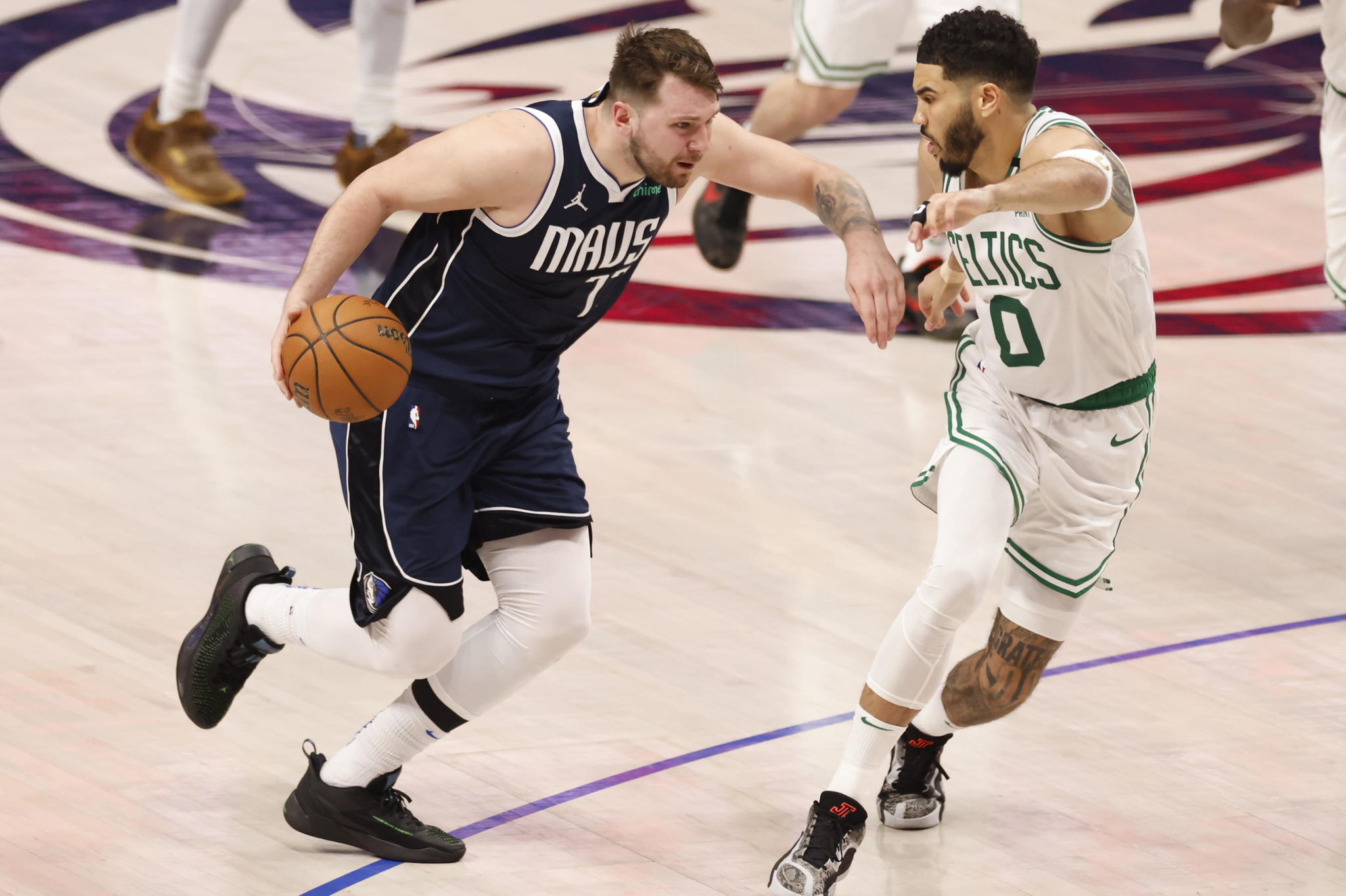 Dallas Mavericks guard Luka Doncic drives by Boston Celtics forward Jayson Tatum