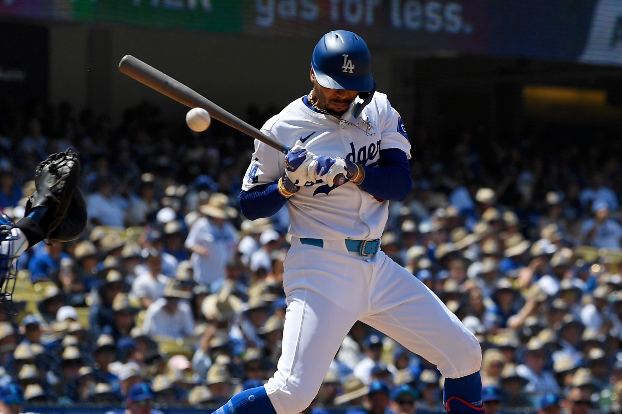 Los Angeles Dodgers Mookie Betts, right, is hit by a pitch as Kansas City Royals catcher Freddy Fermin catches during the seventh inning of a baseball game Sunday, June 16, 2024, in Los Angeles. (AP Photo/Mark J. Terrill)