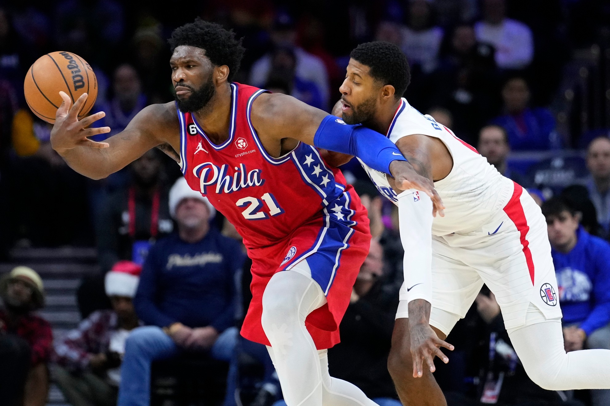 Paul George and Joel Embiid at an NBA game