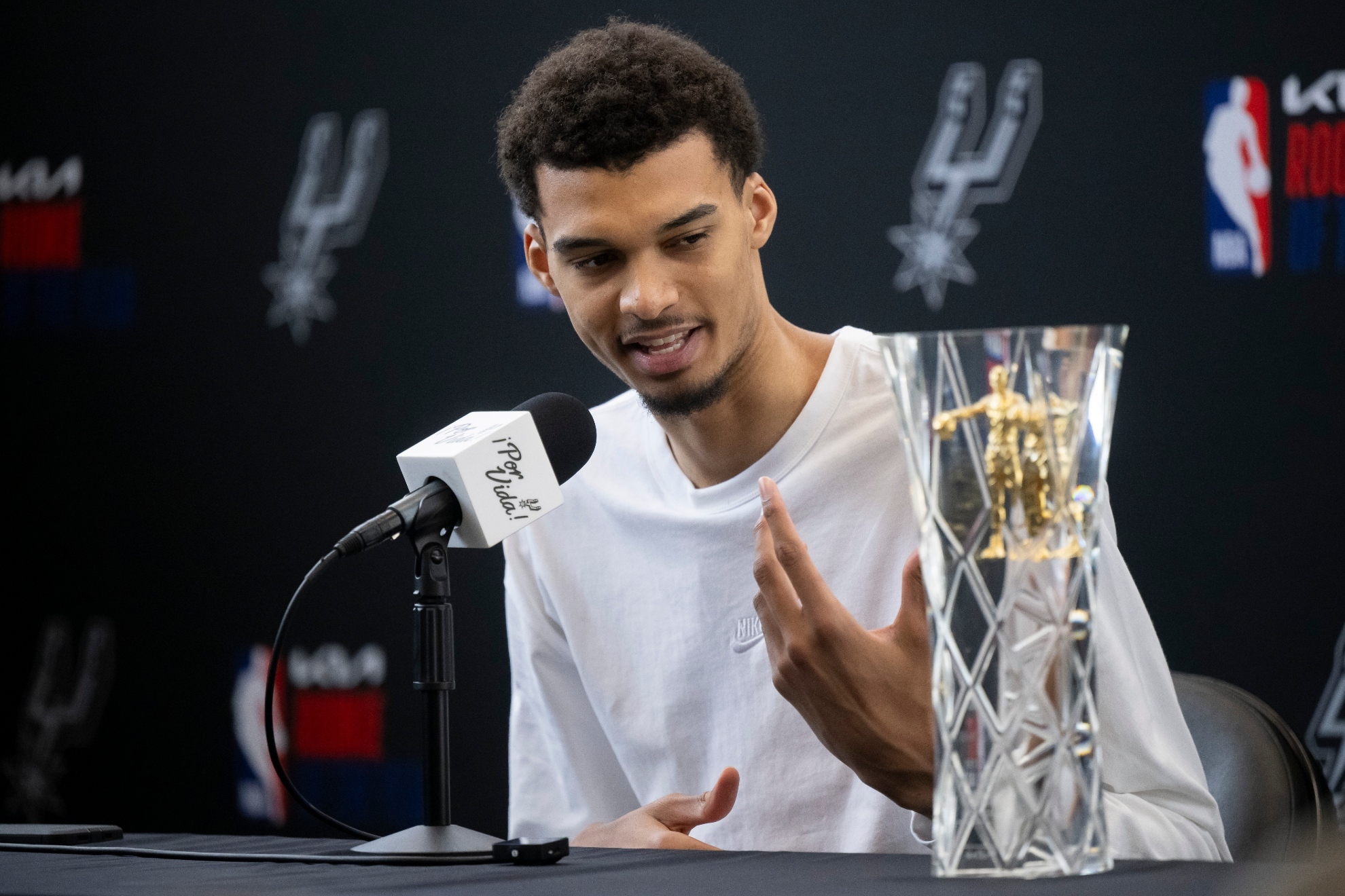 Victor Wembanyama receiving the 2024 NBA Rookie of the Year trophy