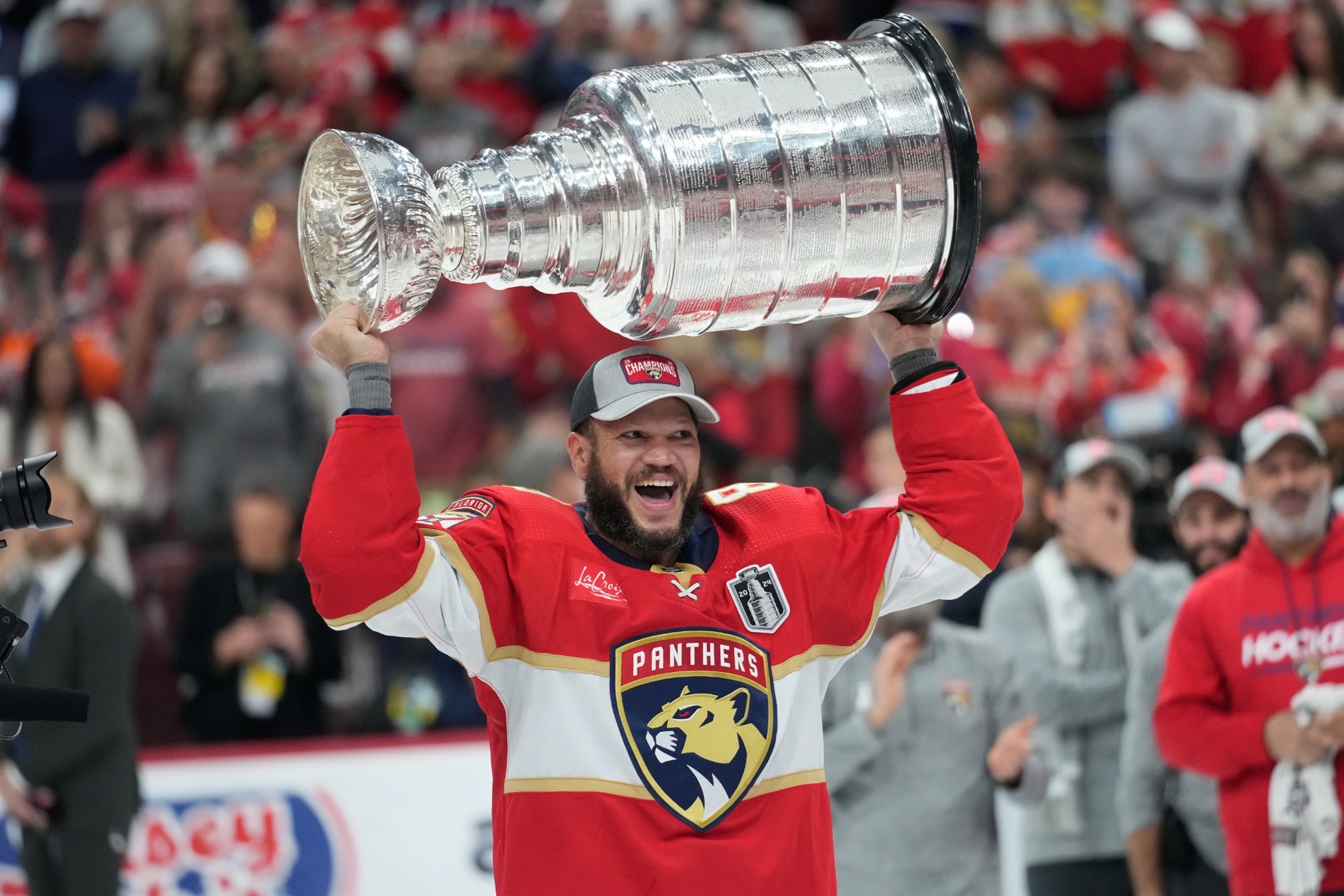 Florida Panthers right wing Kyle Okposo raises the NHL hockey Stanley Cup trophy after defeating the Edmonton Oilers, Monday, June 24, 2024, in Sunrise, Fla. (AP Photo/Wilfredo Lee)