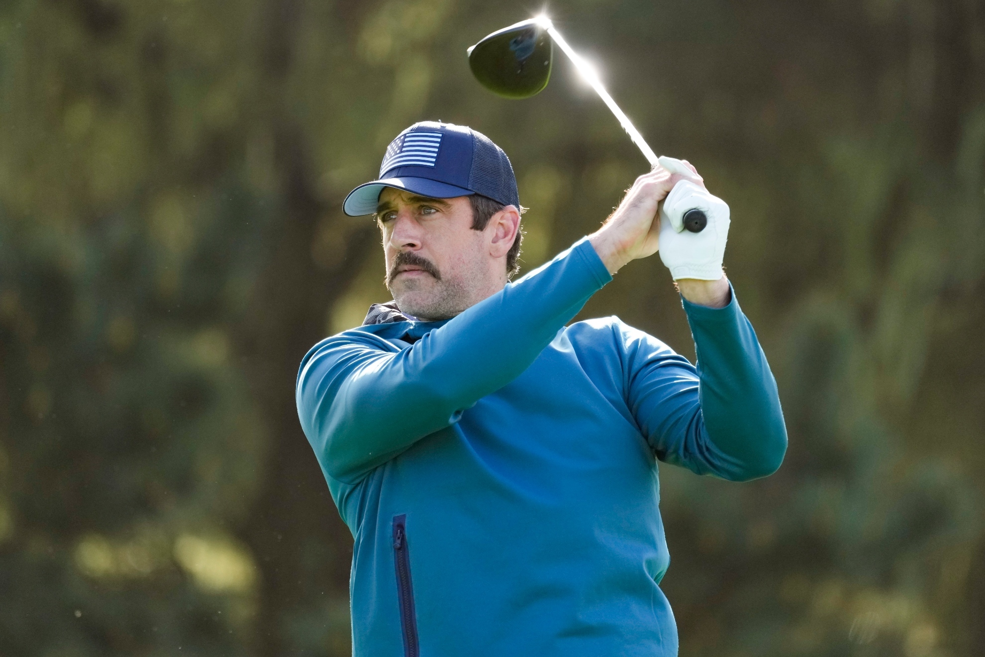 Aaron Rodgers playing golf