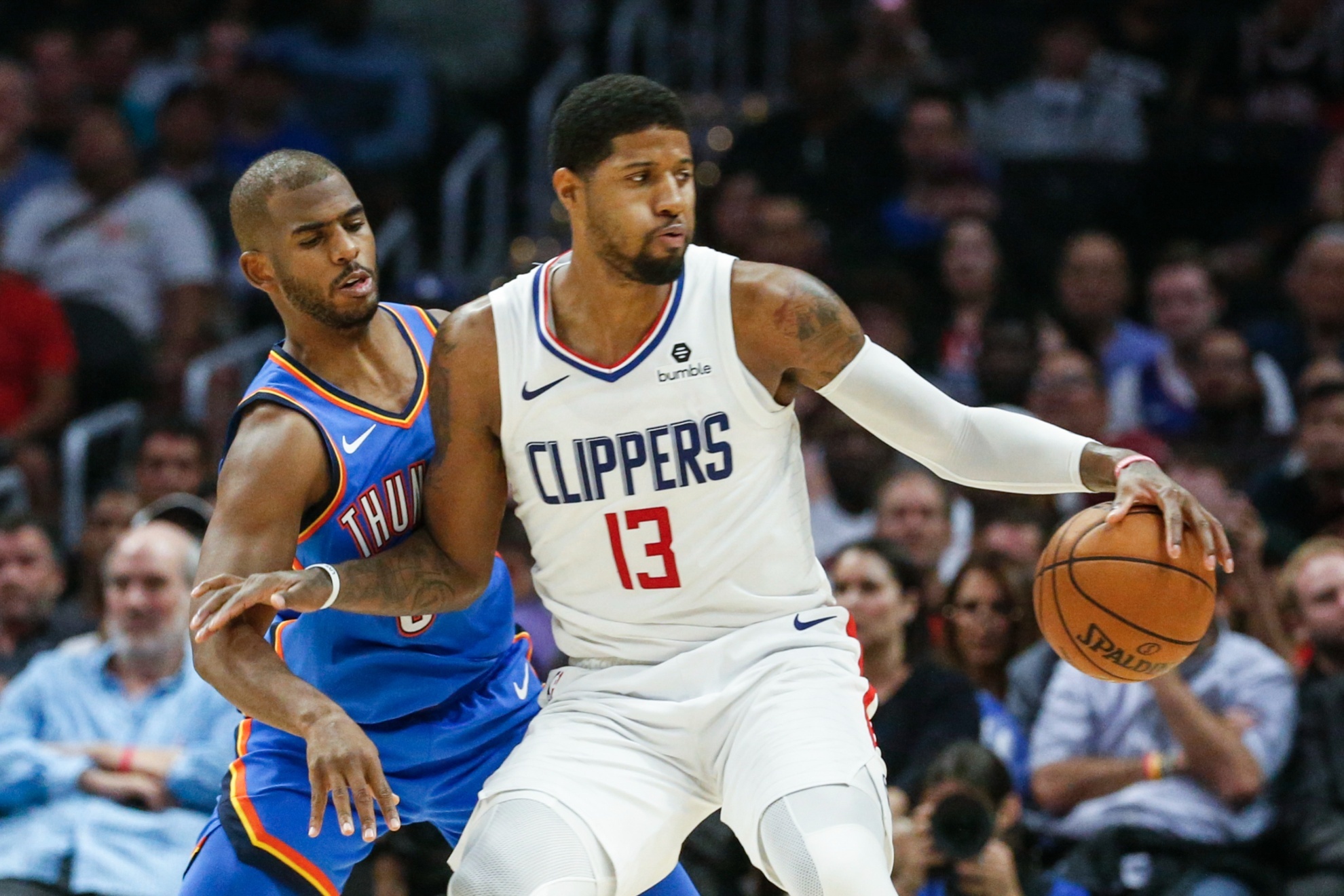 Los Angeles Clippers Paul George (13) is defended by Oklahoma City Thunders Chris Paul (3) during the second half of an NBA basketball game, Monday, Nov. 18, 2019, in Los Angeles. The Clippers won 90-88. (AP Photo/Ringo H.W. Chiu)