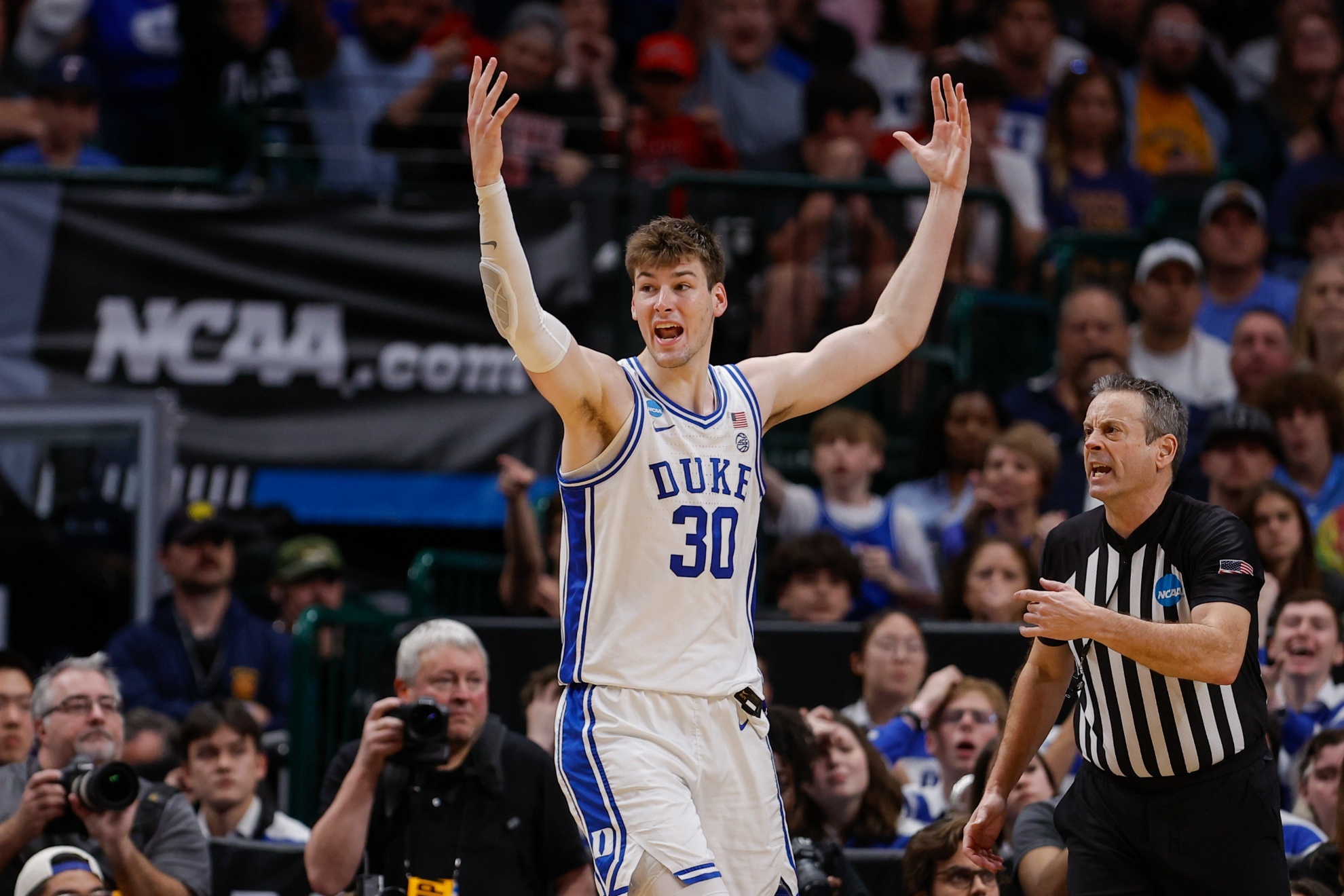 Dukes Kyle Filipowski reacts while standing next to referee Doug Sirmons during the second half of an Elite Eight college basketball game against North Carolina State in the NCAA Tournament in Dallas, Sunday, March 31, 2024. (AP Photo/Brandon Wade)