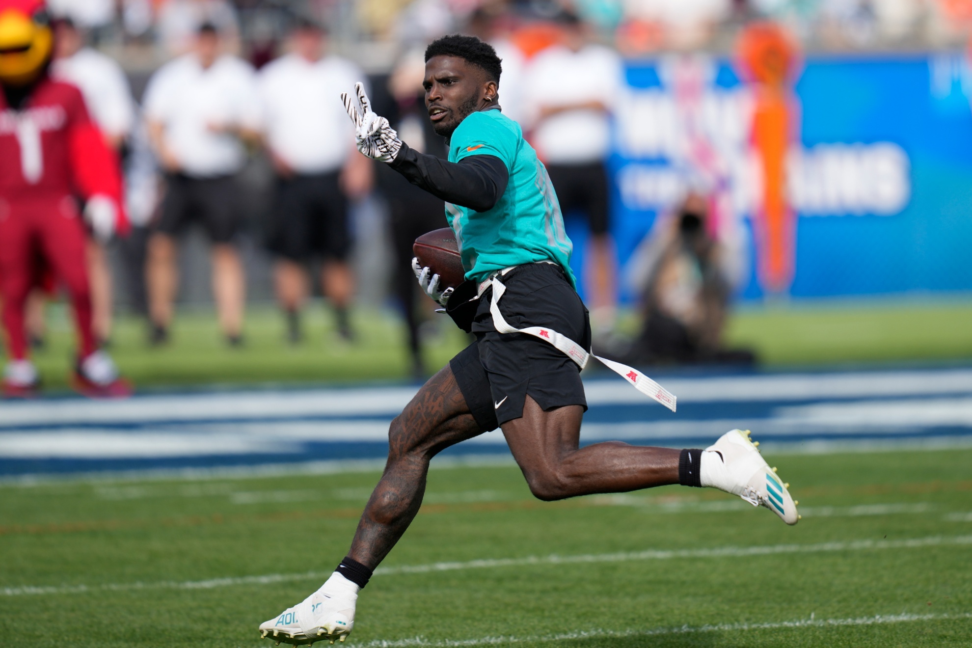 AFC wide receiver Tyreek Hill, of the Miami Dolphins, scores a touchdown during the flag football event at the NFL Pro Bowl football game, Sunday, Feb. 4, 2024, in Orlando. (AP Photo/John Raoux)