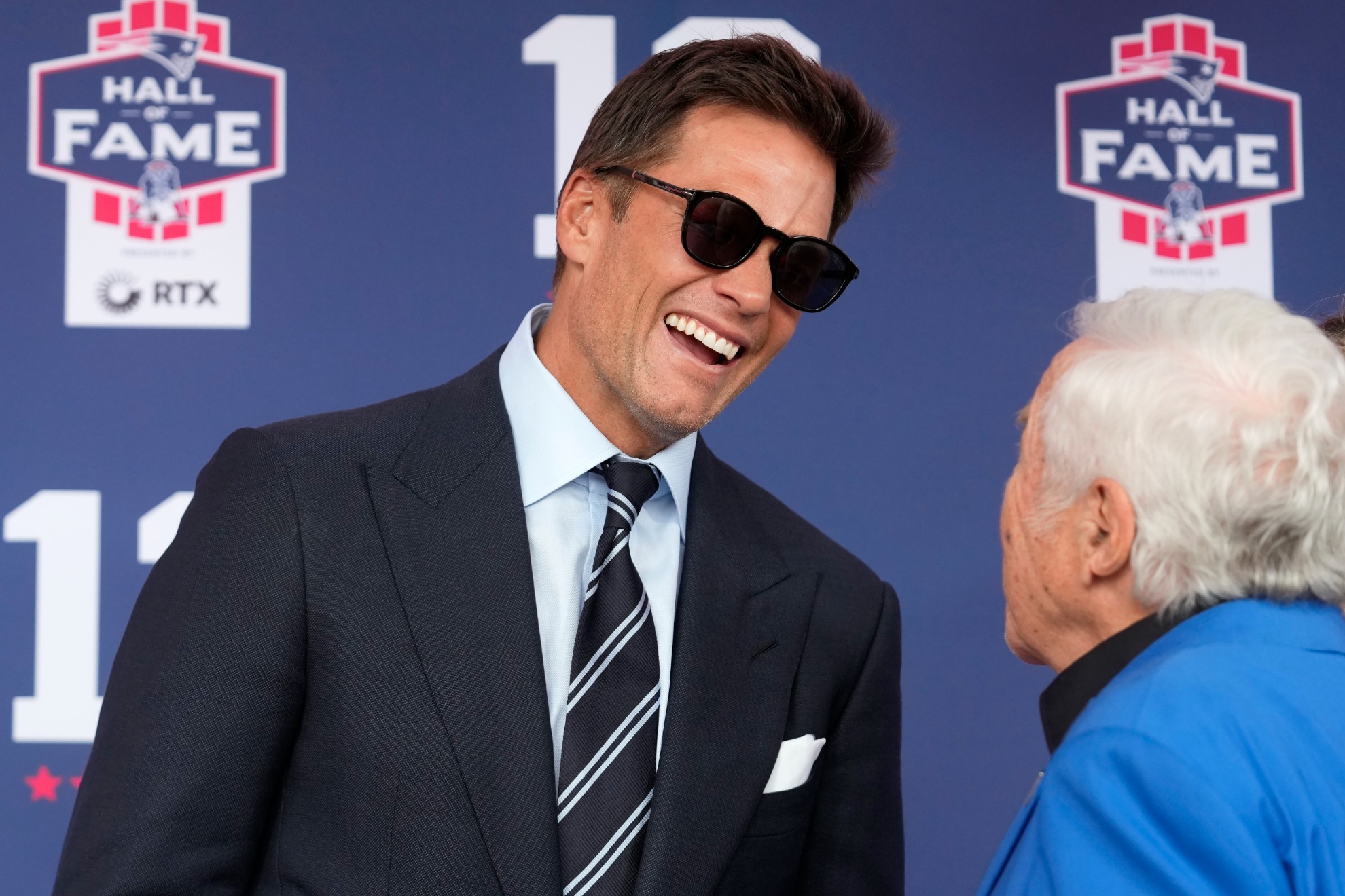 Former New England Patriots quarterback Tom Brady, left, speaks with Patriots owner Robert Kraft as they arrive for the Patriots Hall of Fame induction ceremony for Brady at Gillette Stadium, Wednesday, June 12, 2024, in Foxborough, Mass. (AP Photo/Steven Senne)