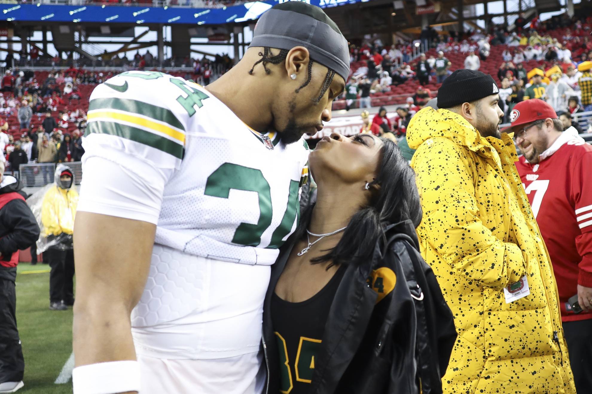 Green Bay Packers safety Jonathan Owens (34) and Simone Biles kiss before an NFL football NFC divisional playoff game between the Packers and the San Francisco.