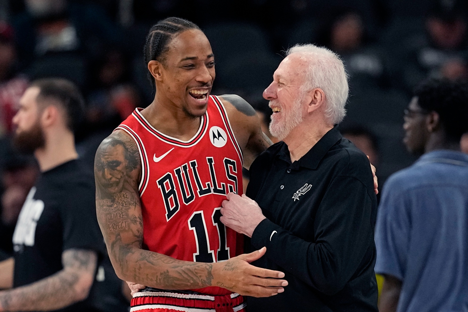 Chicago Bulls forward DeMar DeRozan (11) laughs with San Antonio Spurs coach Gregg Popovich before an NBA basketball game in San Antonio, Saturday, Jan. 13, 2024. (AP Photo/Eric Gay)