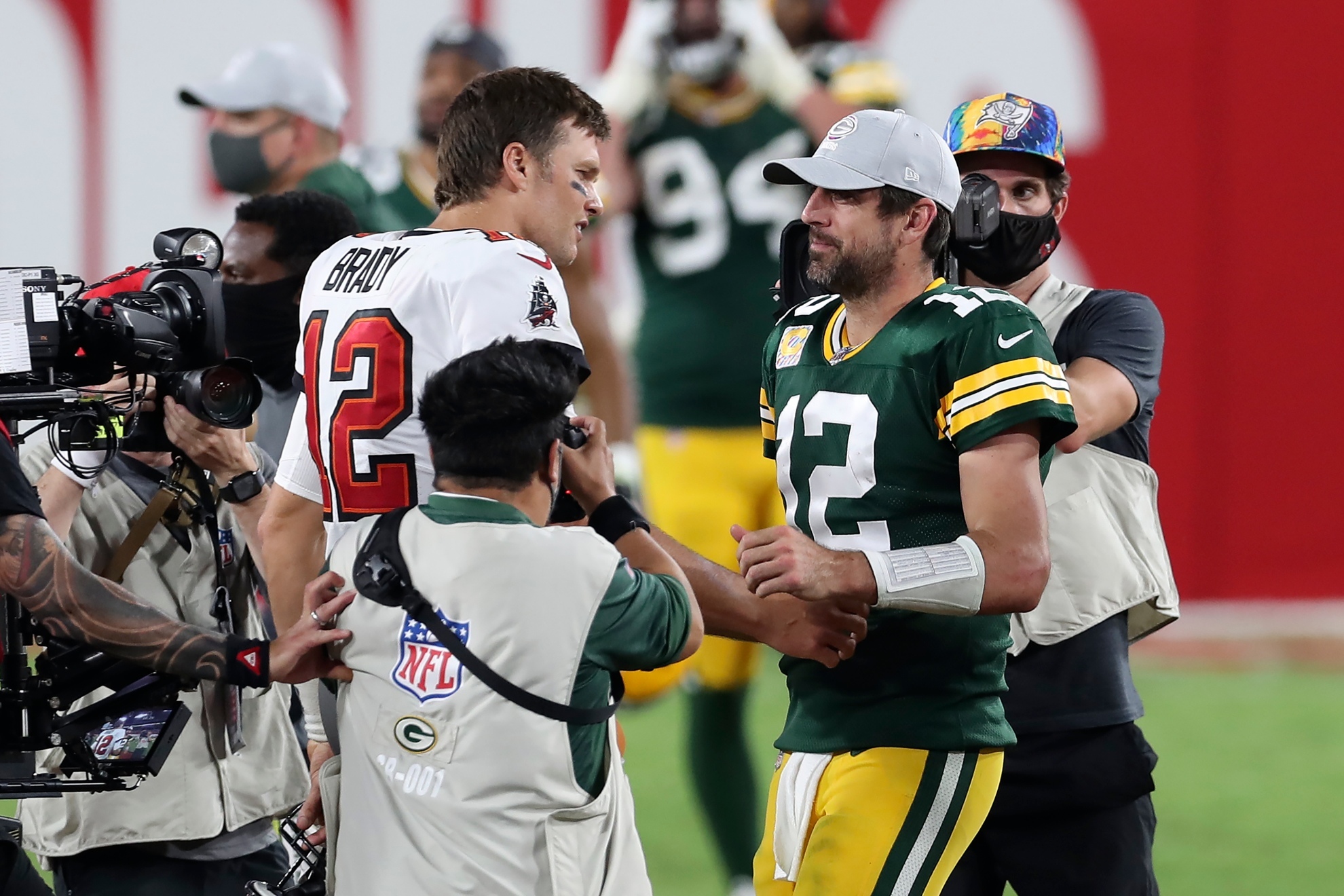 Tom Brady greeting Aaron Rodgers